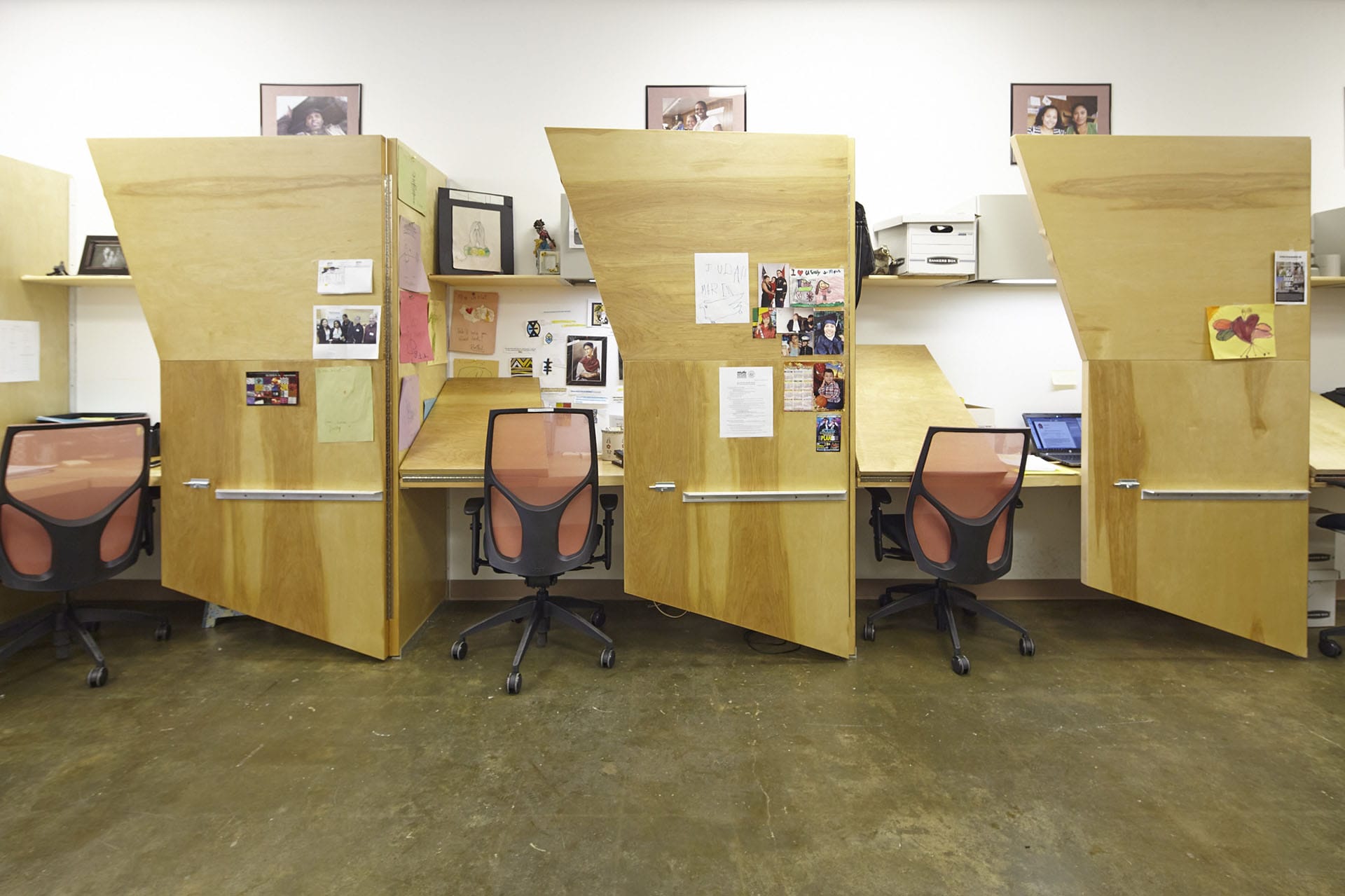 Wood cubicles which can be transitioned from a divided office to an open community space.