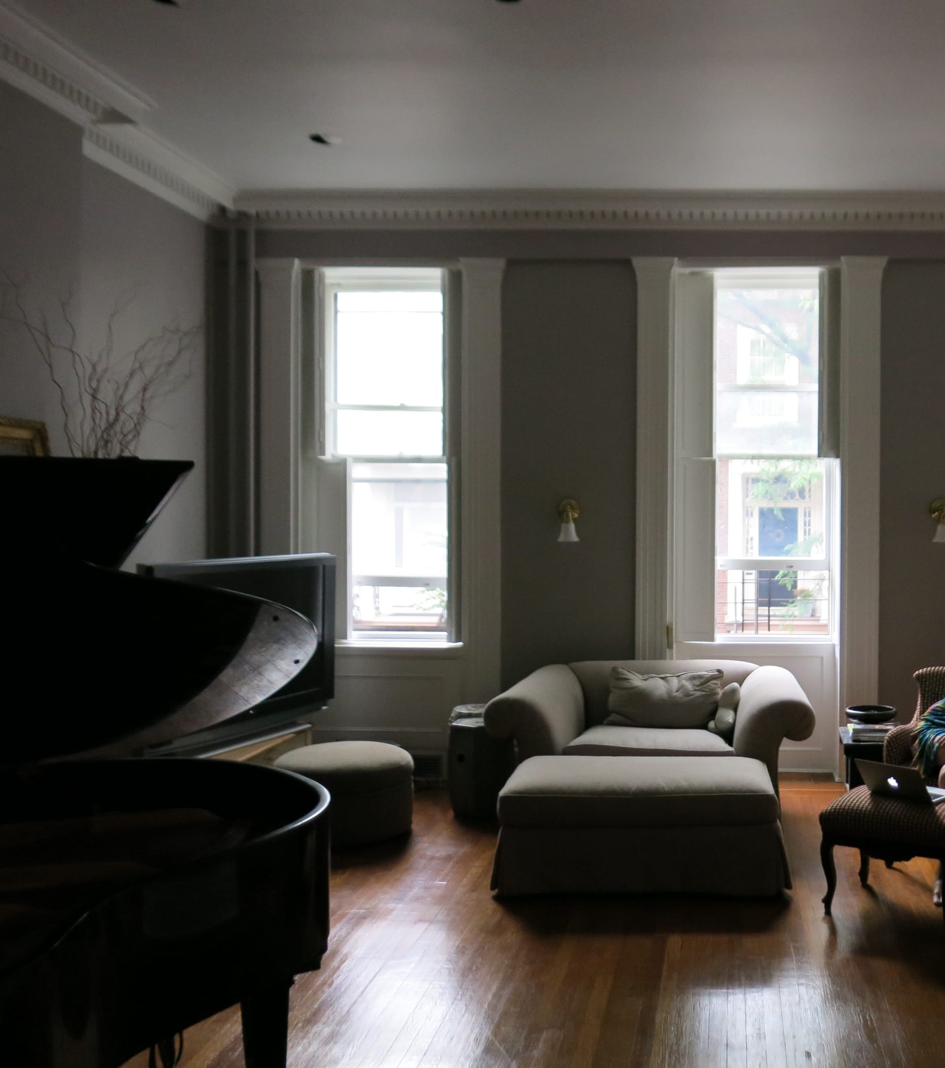 Living room with wood floors and grey painted walls before our renovation