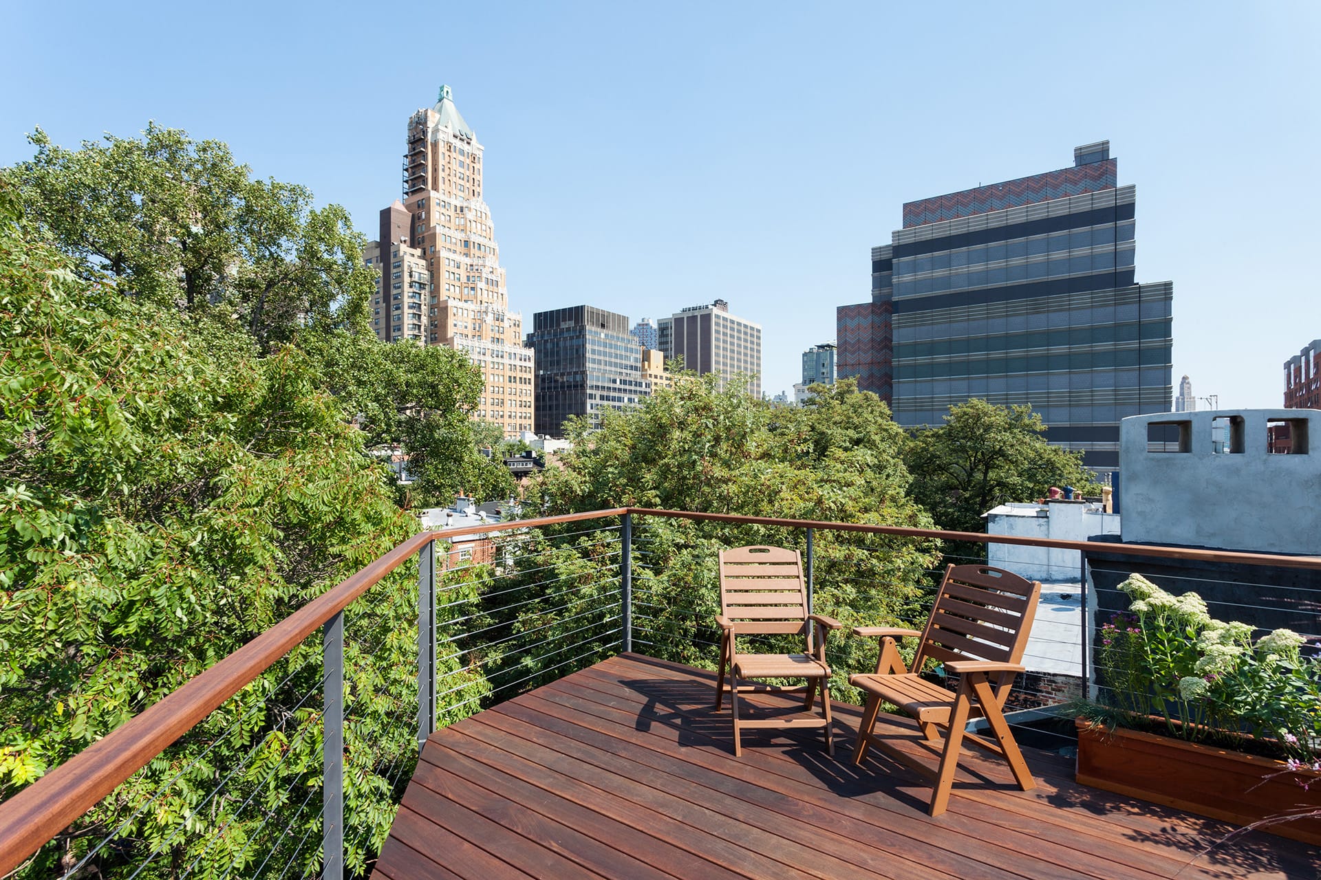 Roof deck with two chairs and Manhattan views in a Brooklyn Heights townhouse