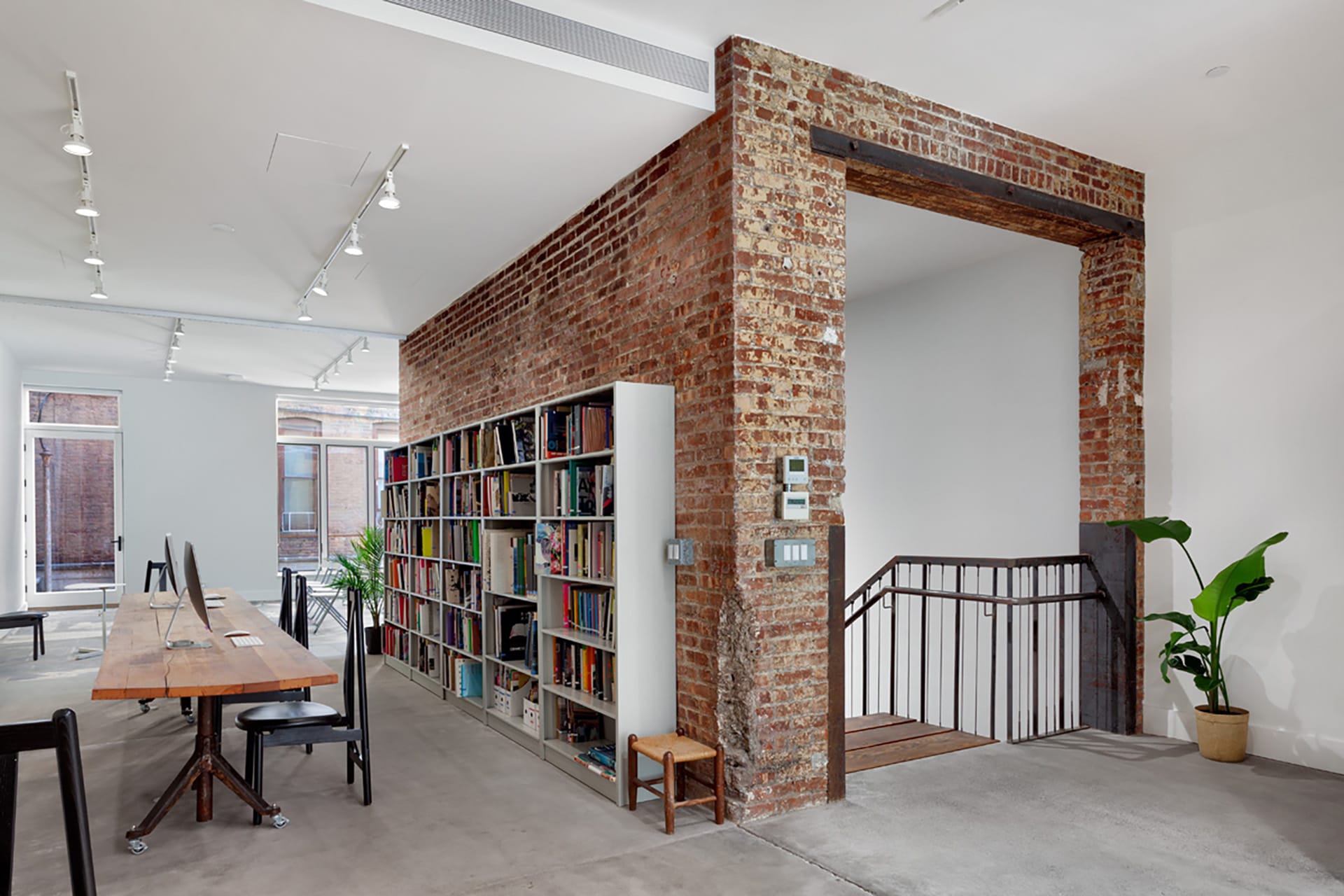 Elevator shaft with restored exposed brick converted into a stairwell.