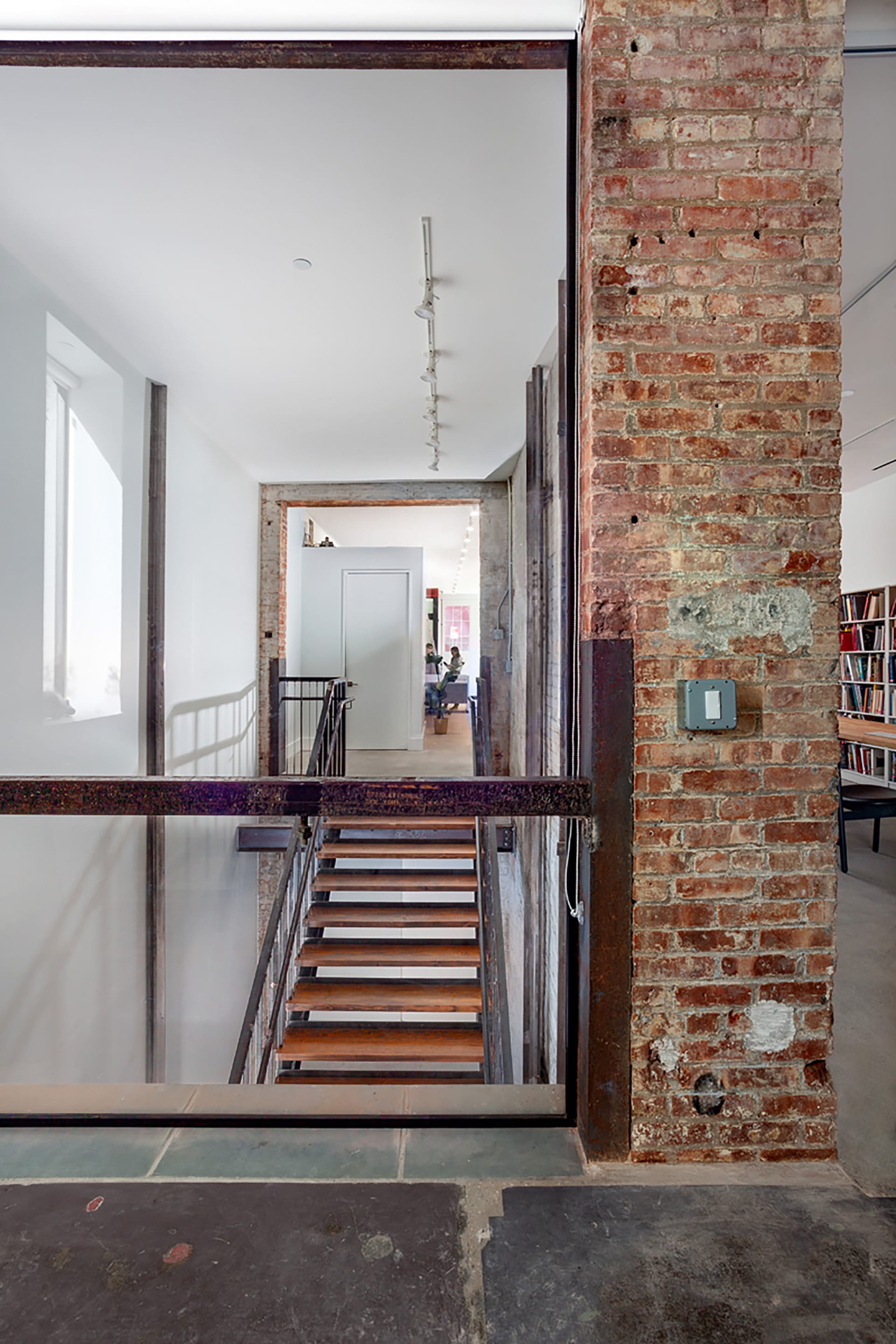 Elevator shaft with restored exposed brick converted into a stairwell.