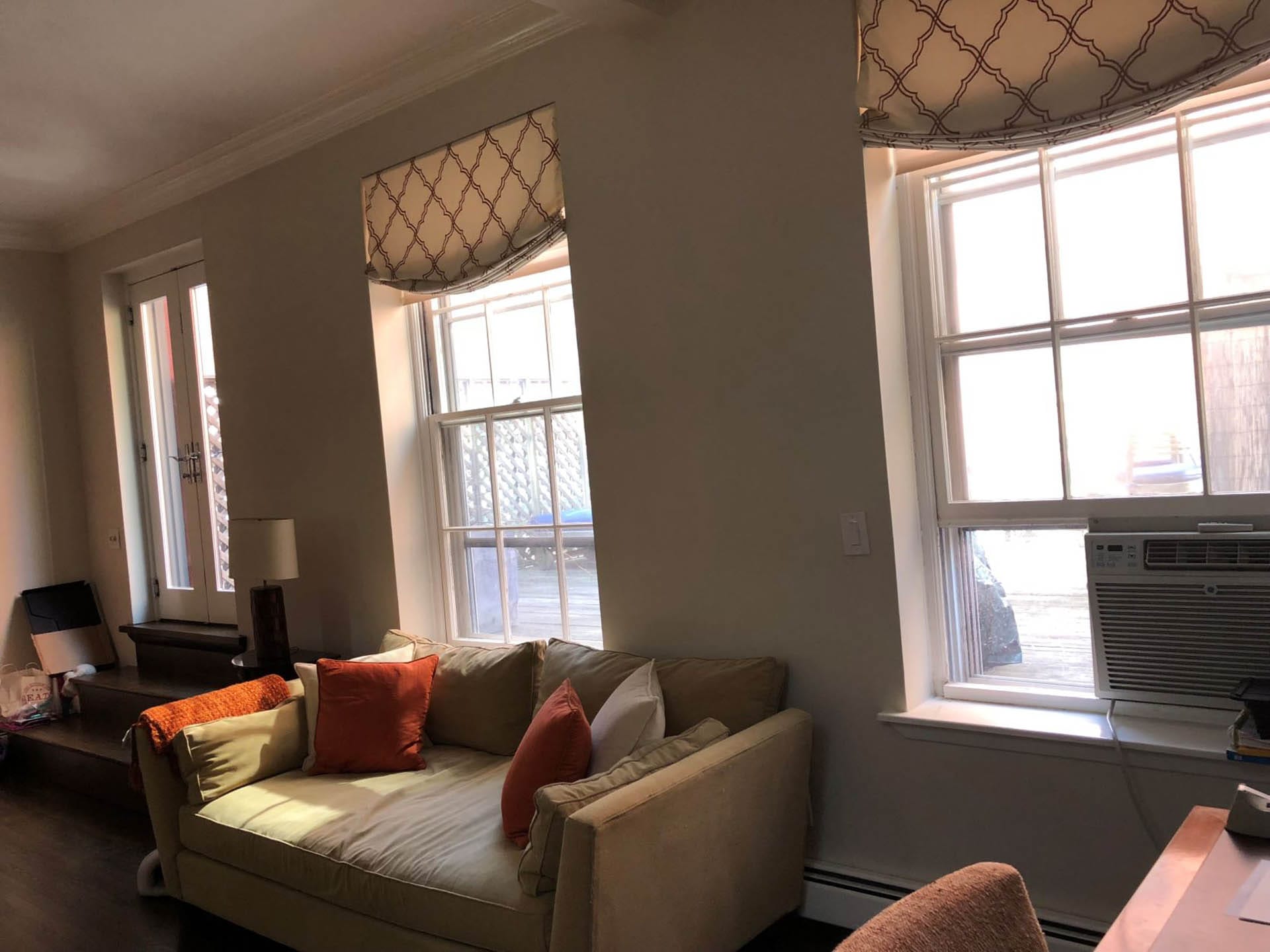 Living room in a Brooklyn Heights apartment with French doors leading out to the deck.