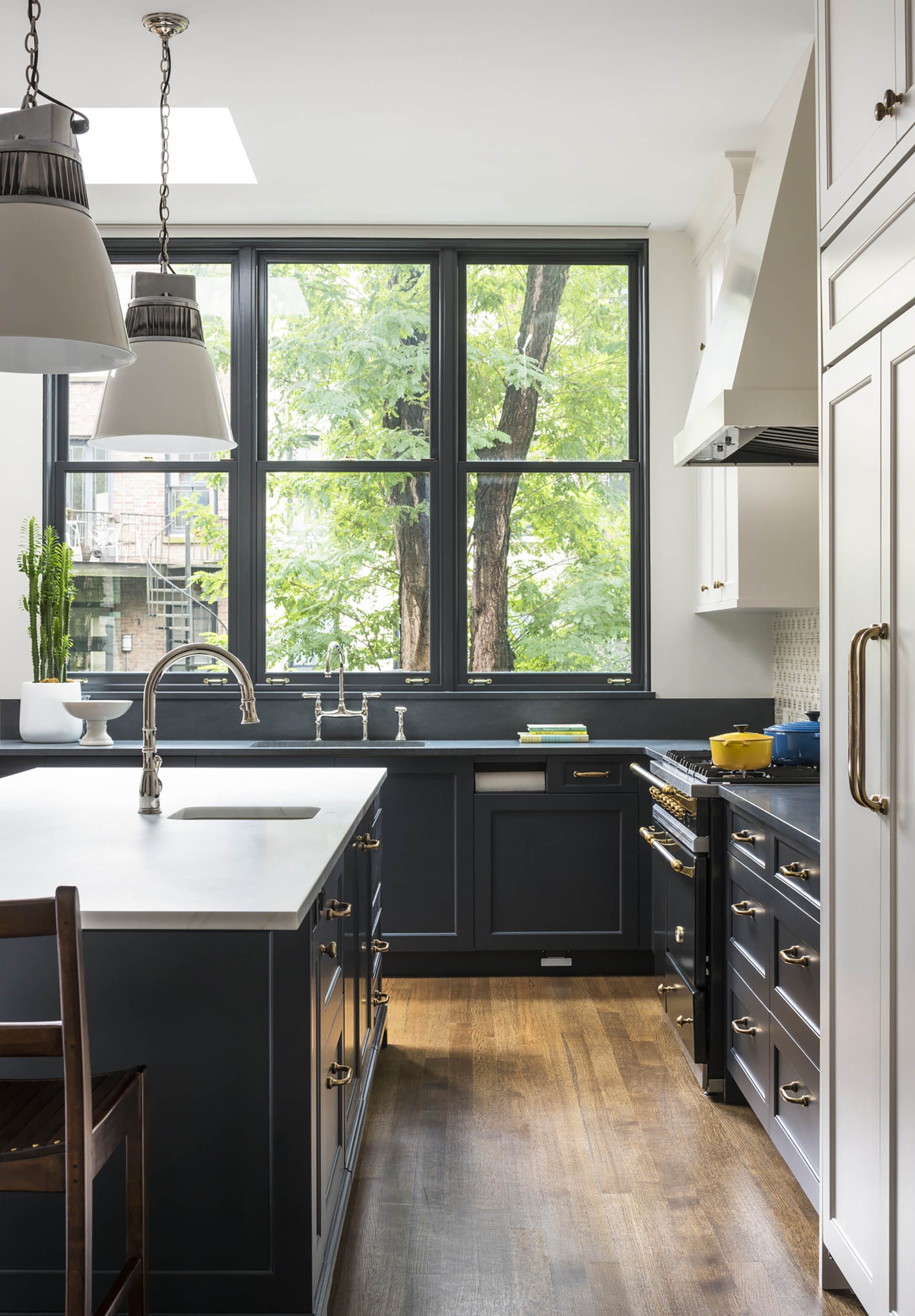 Expanded kitchen with enlarged windows, a new island, and a new skylight.