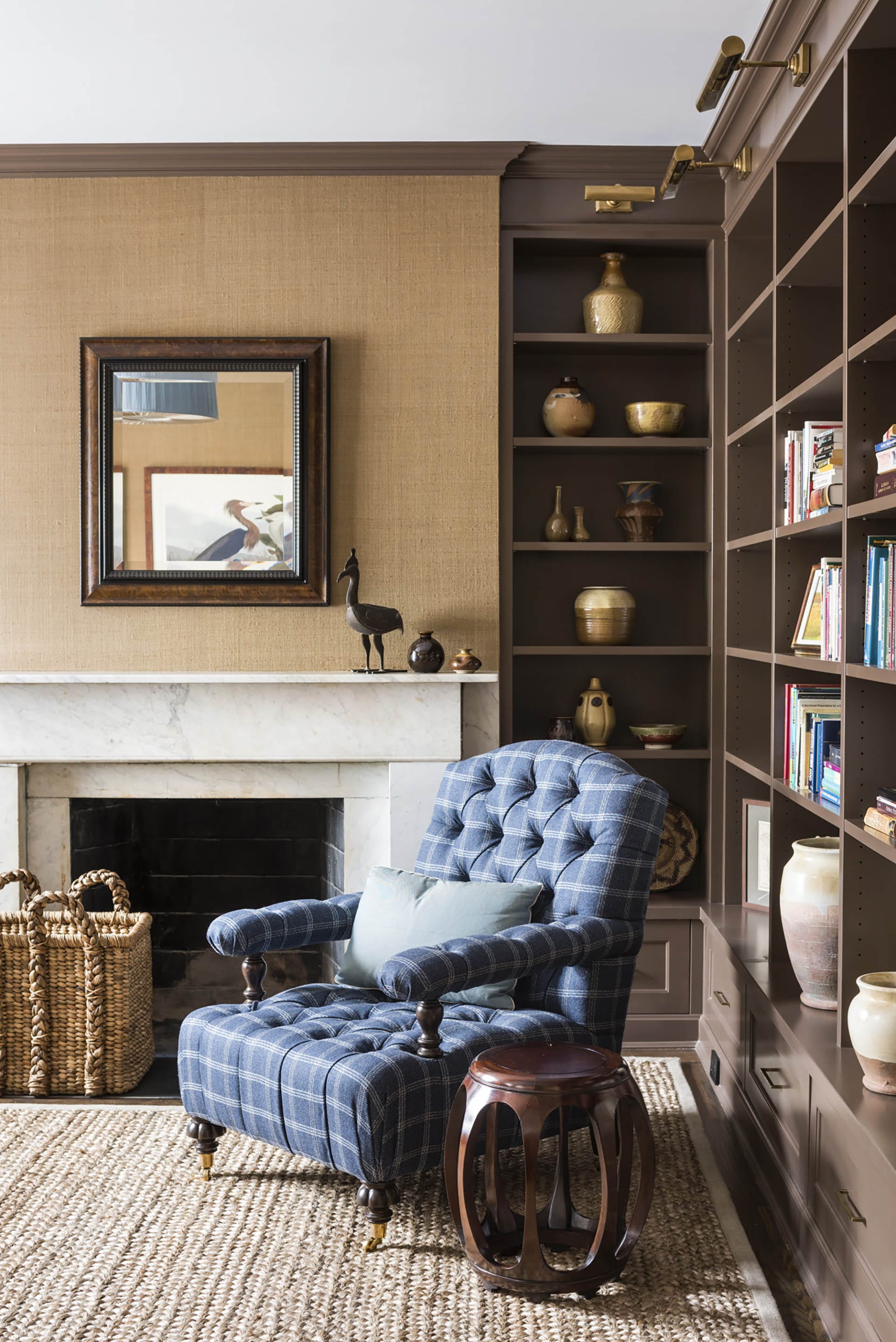 Living room with built-in bookshelves and a blue plaid armchair.