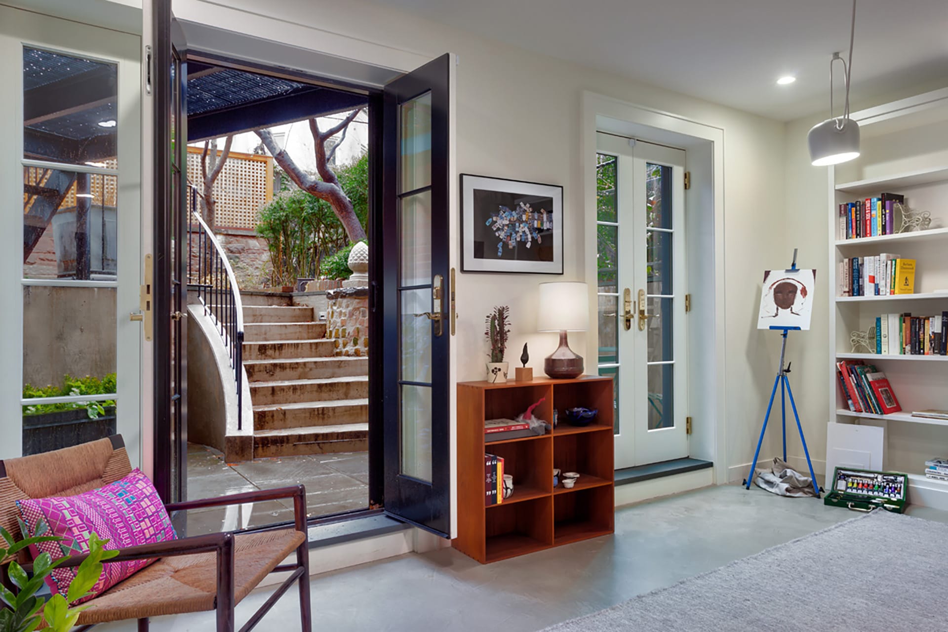 Rear garden floor of a Brooklyn Heights townhouse with a new areaway leading up to the rear yard and two sets of French doors leading outside