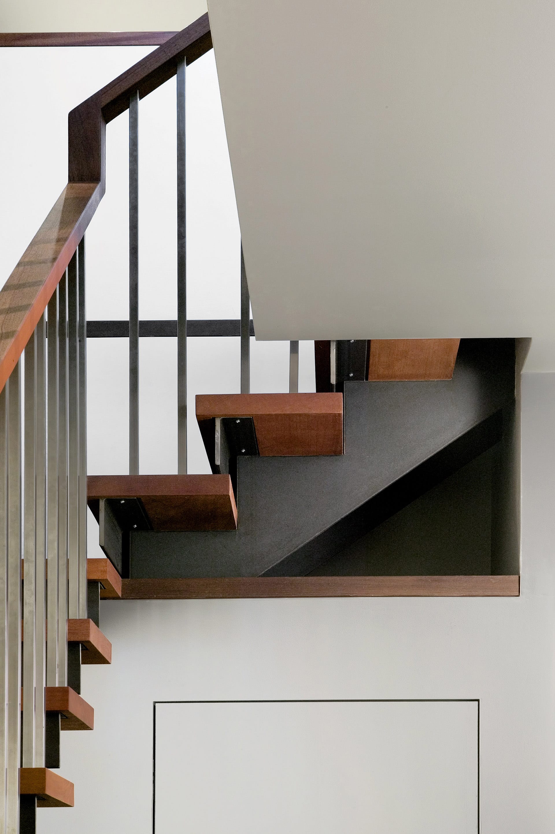Detail image of a modern, open riser, open stringer staircase in a Cobble Hill townhouse