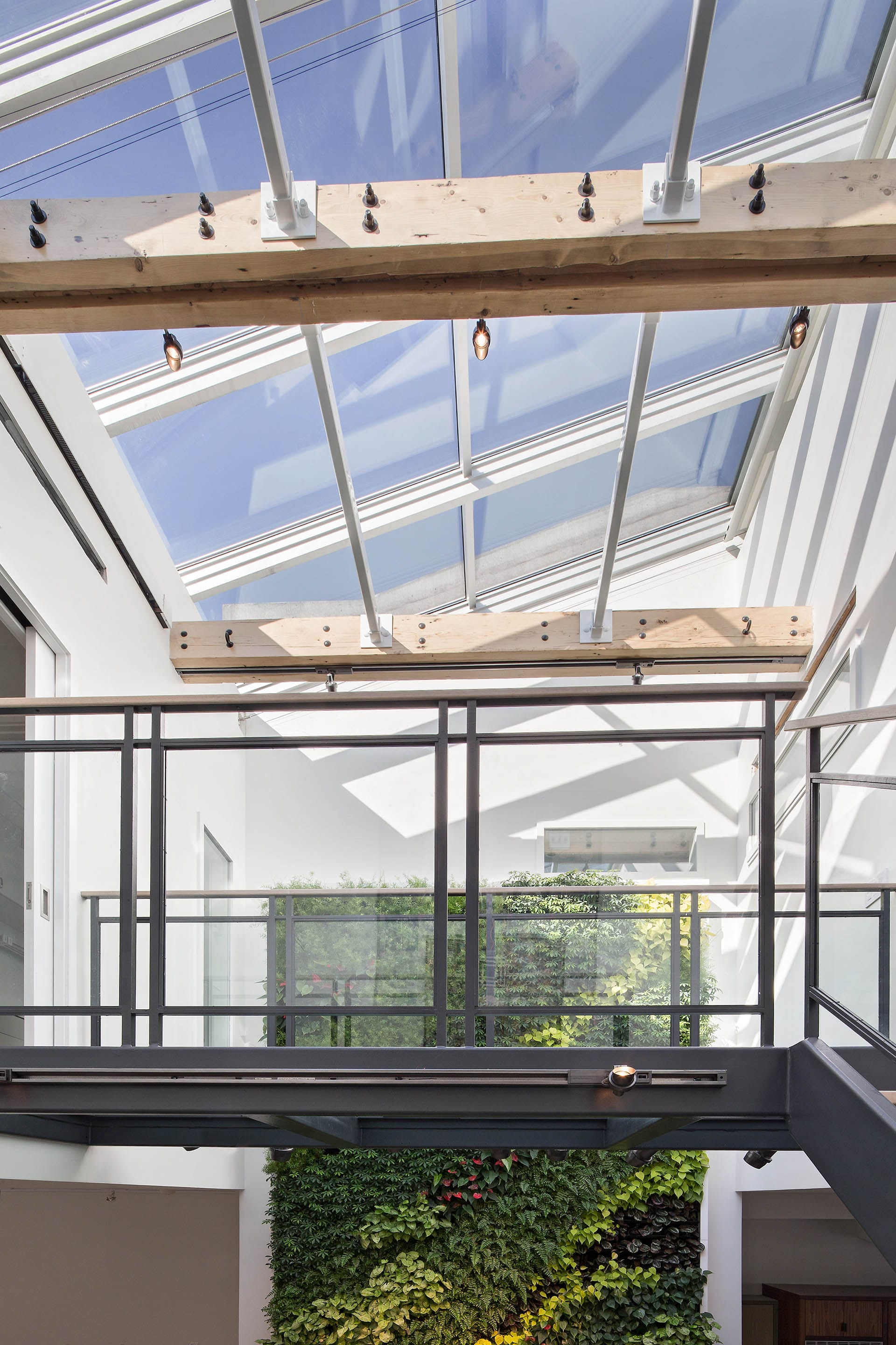 Floating walkway connecting the primary bedroom suite to the front of the house's third floor