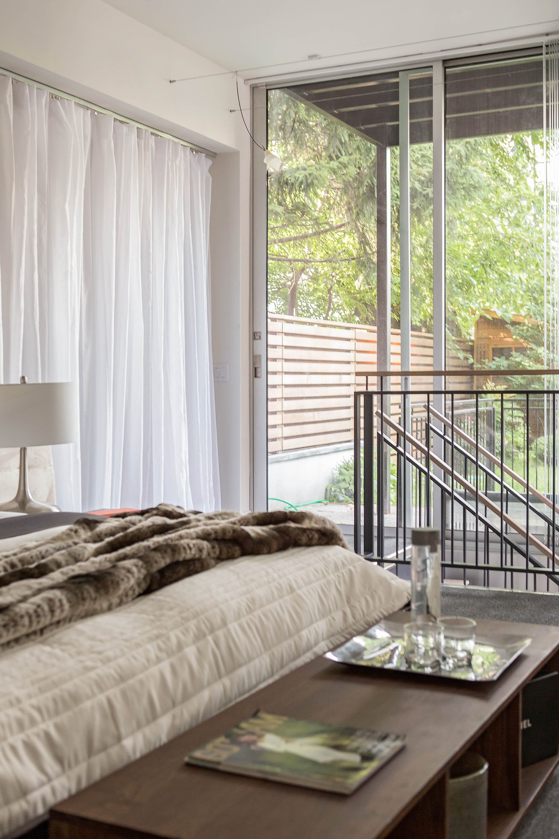 First-floor guest bedroom with a sliding glass door that leads out to the back yard.