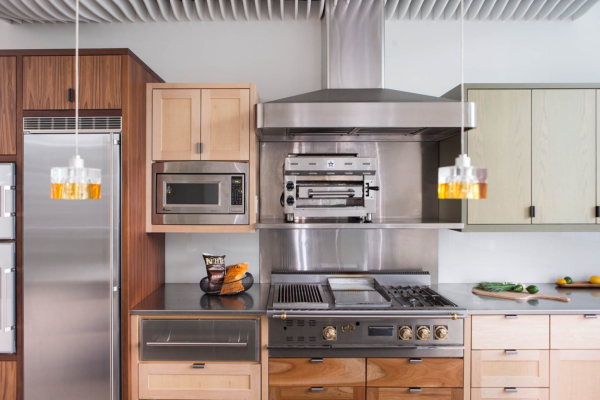 Kitchen with stainless steel appliances and mixed wood cabinetry.