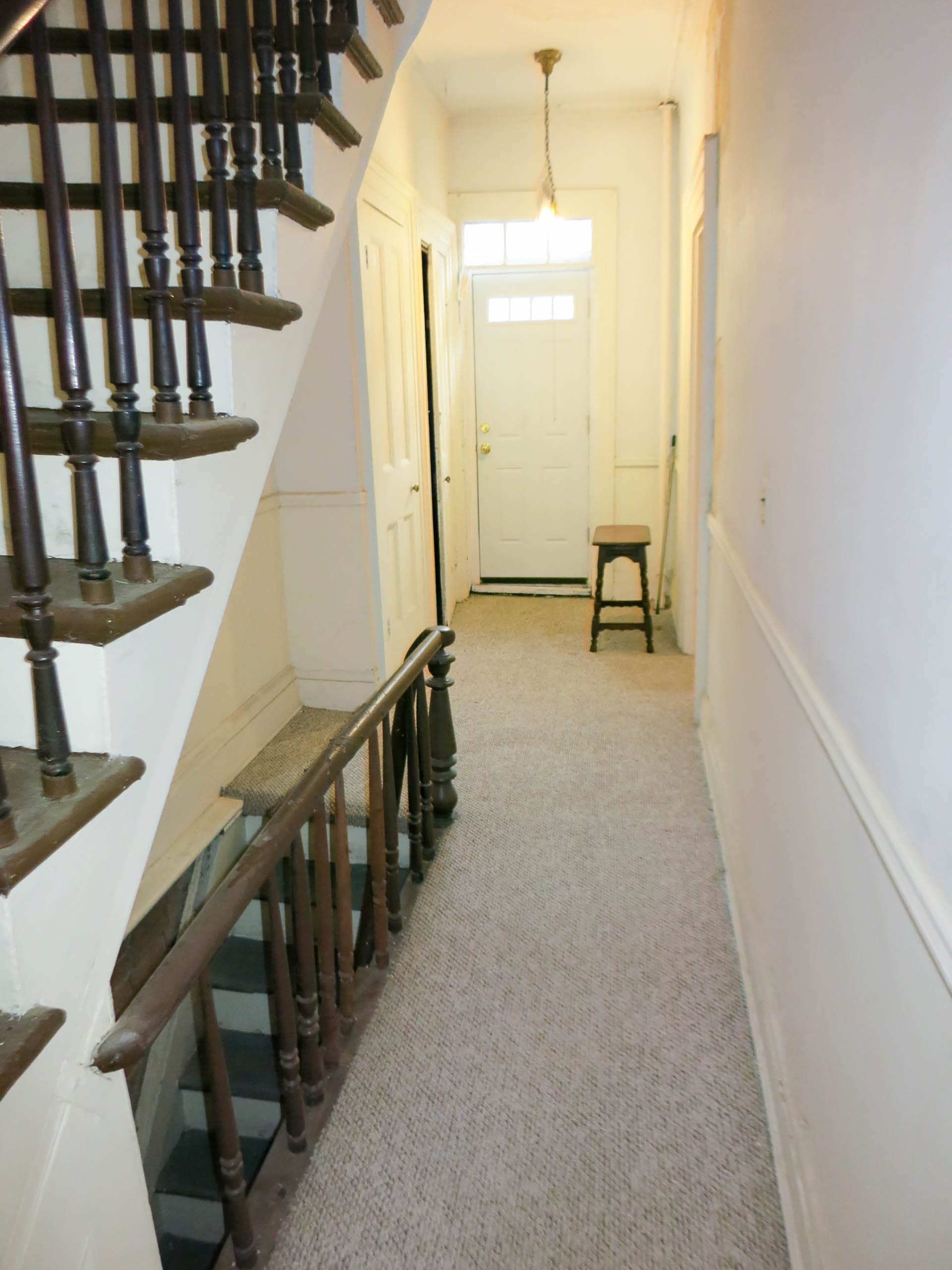 Entryway and staircase of a Brooklyn Heights home before renovation.