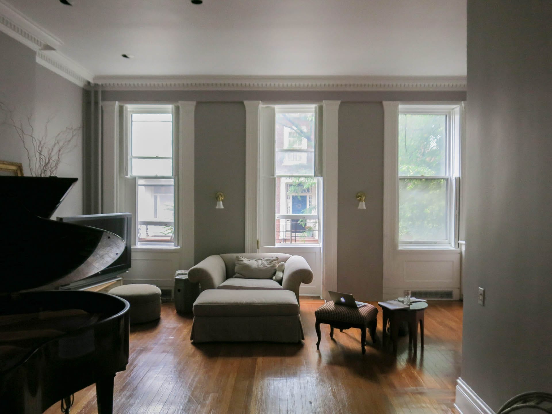 Living room with historic crown molding, wood floors, and grey painted walls before our renovation