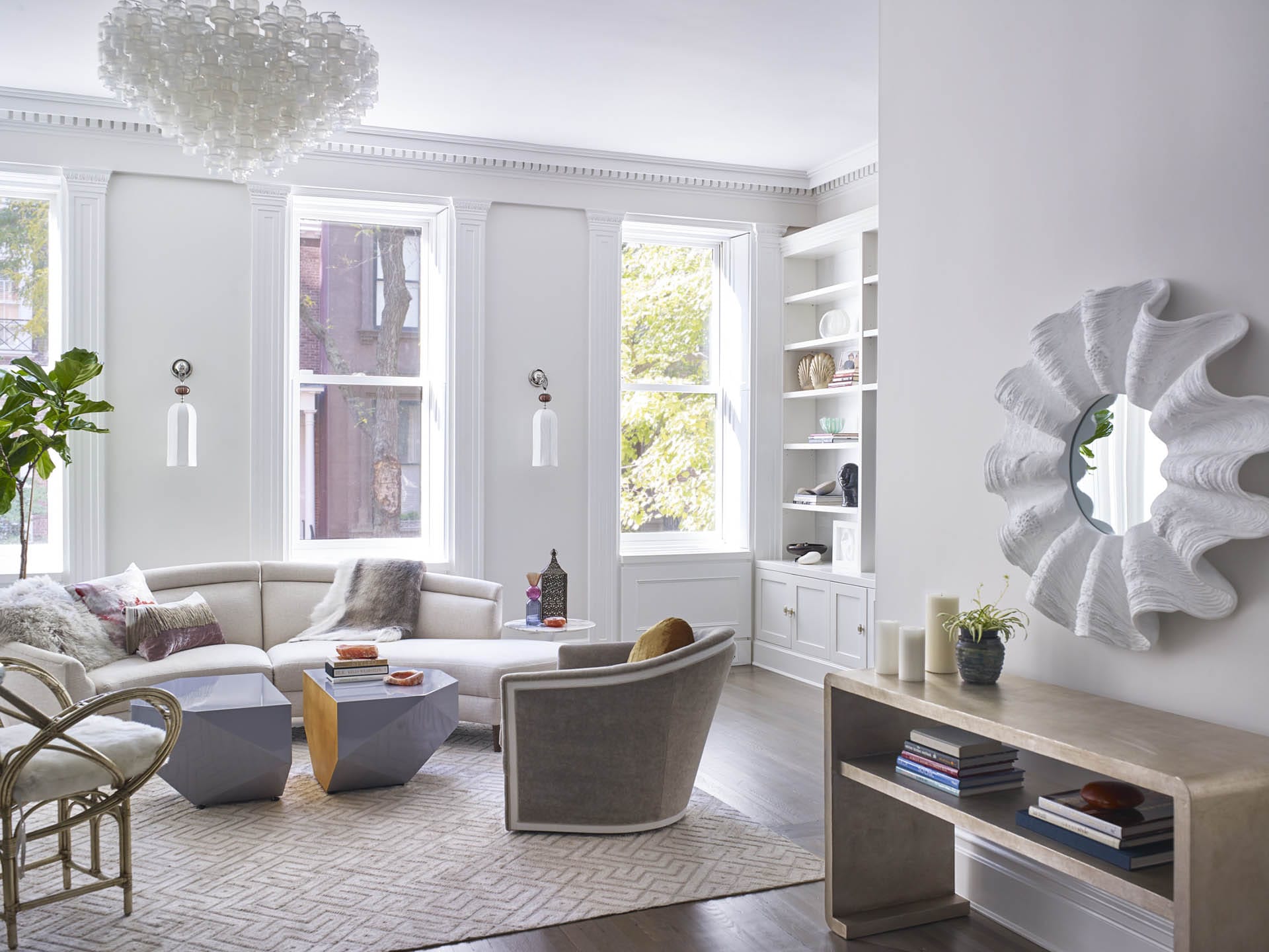 Living room with preserved historic details, white walls, and eclectic modern furnishings.