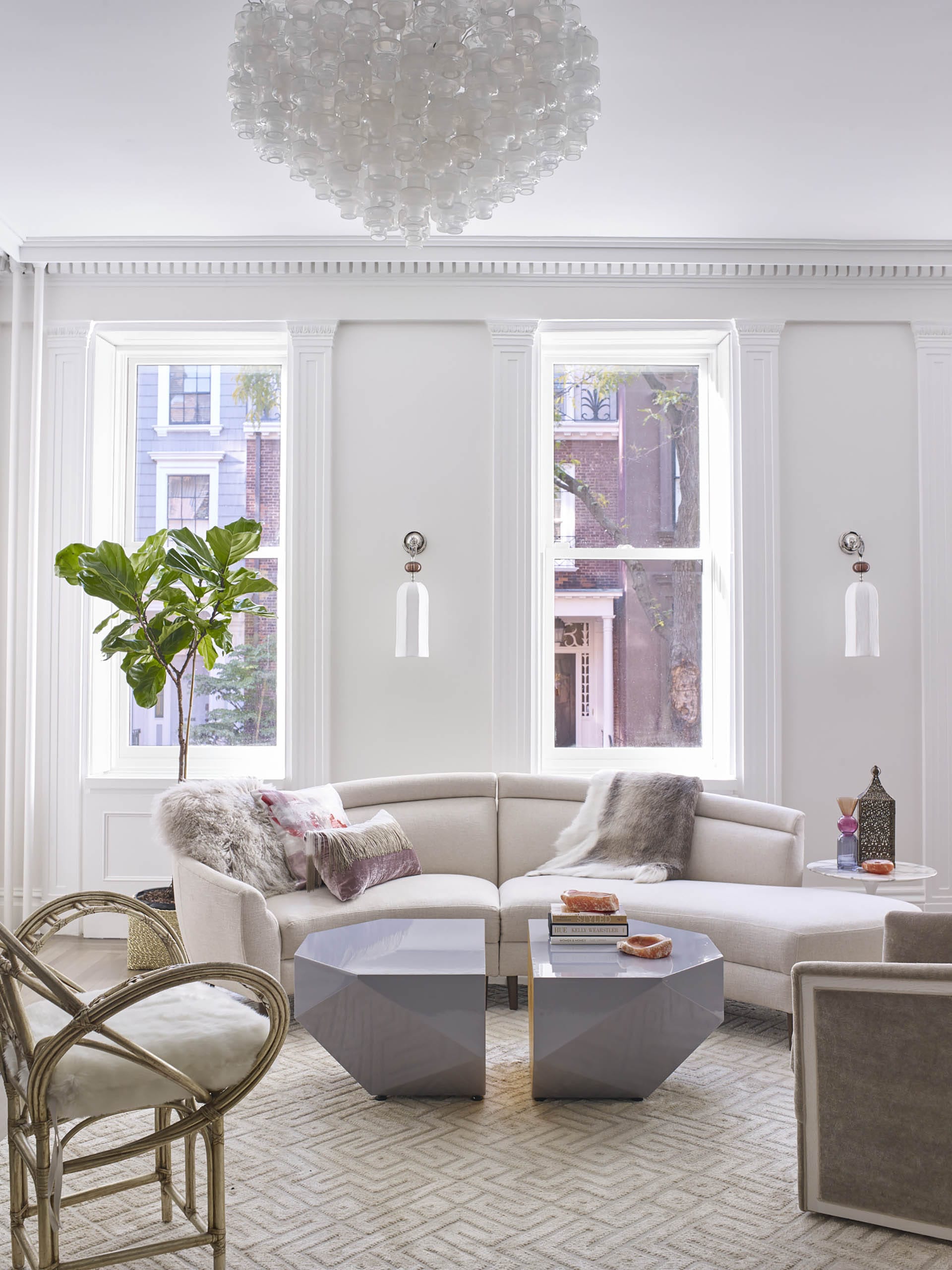 Living room with preserved historic details, white walls, and eclectic modern furnishings.