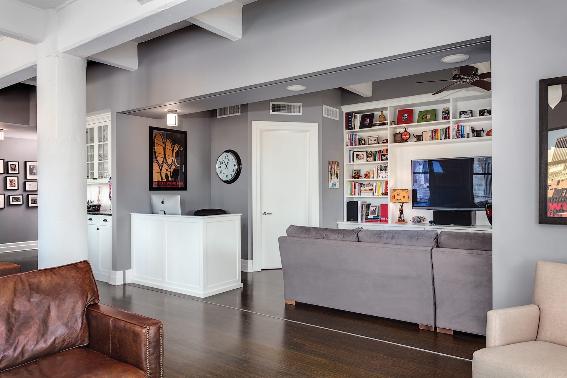 TV room visible from a living room through a large entryway with hidden pocket doors