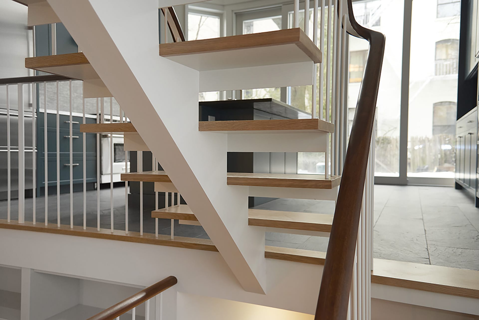 Detail shot of a staircase in a Brooklyn Heights Historic District townhouse with open stringers and open risers.