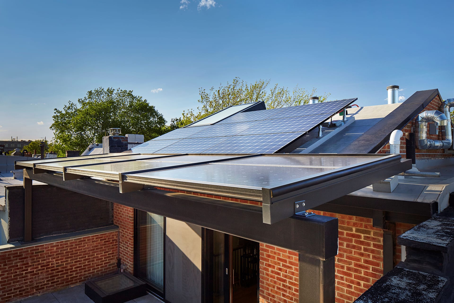 Solar canopy that doubles as an awning shading a rooftop patio.