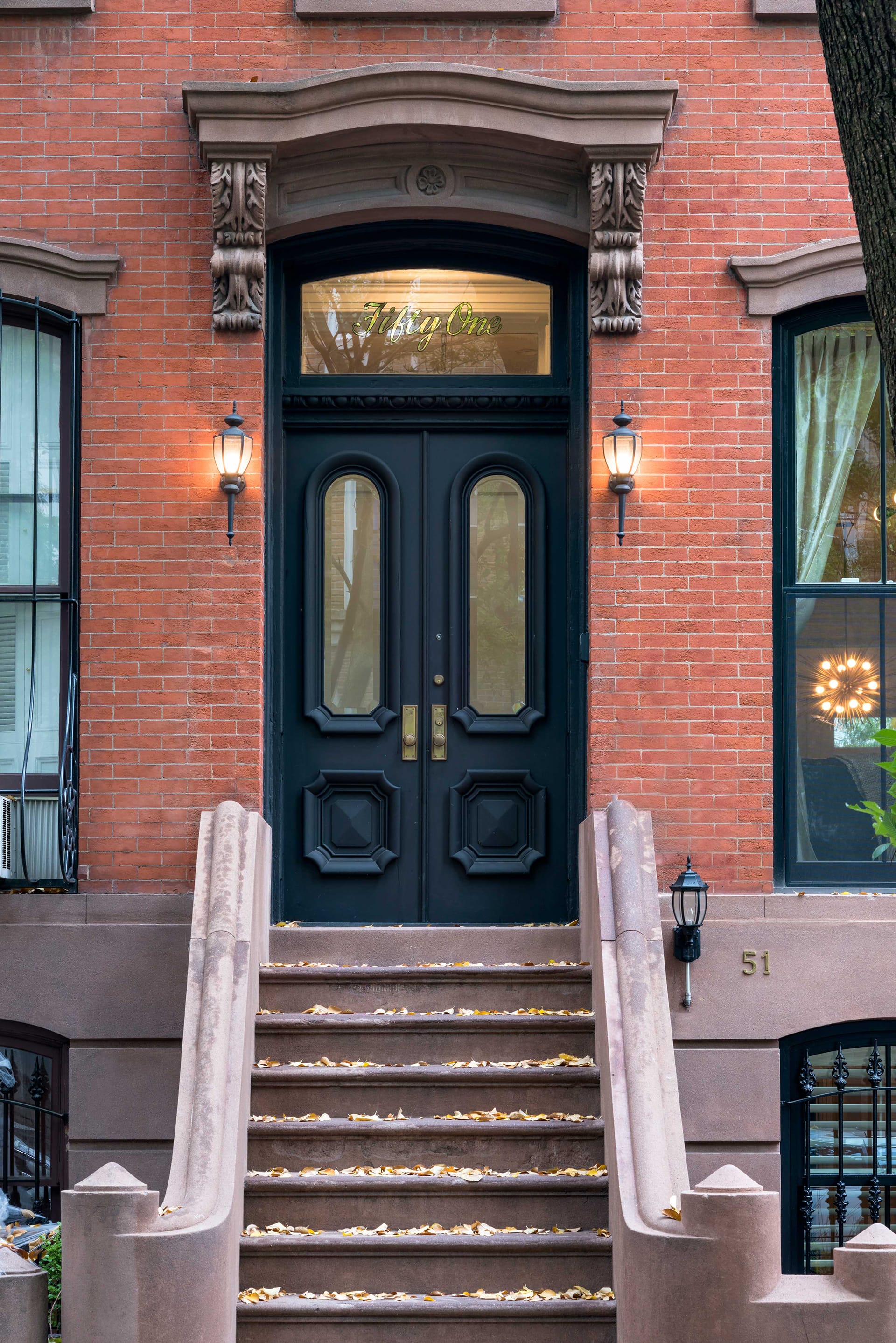 Front door and stoop of a brick Fort Green townhouse