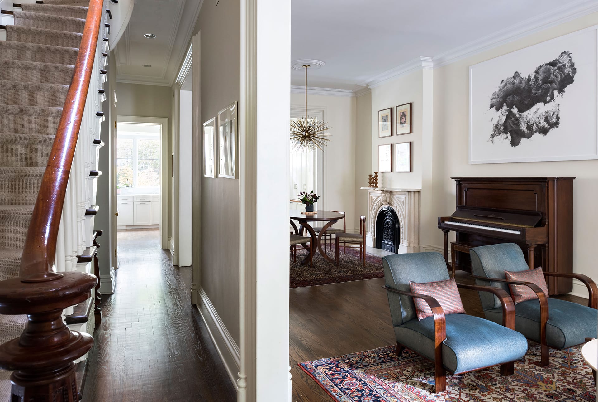 Staircase and hallway adjacent to the living and dining area of a Fort Green townhouse