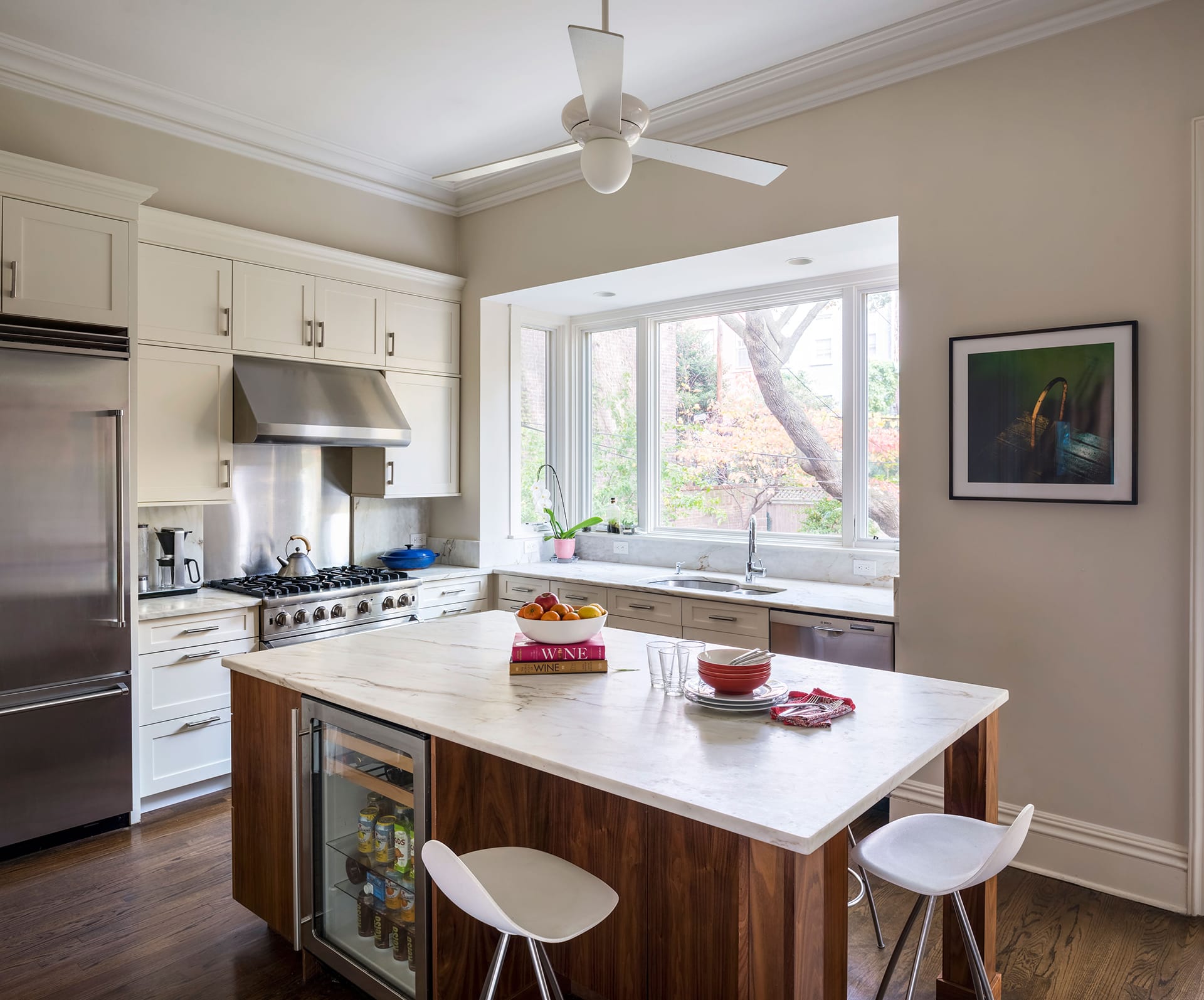 Kitchen with a large bay window, white countertops, and white millwork in Fort Green