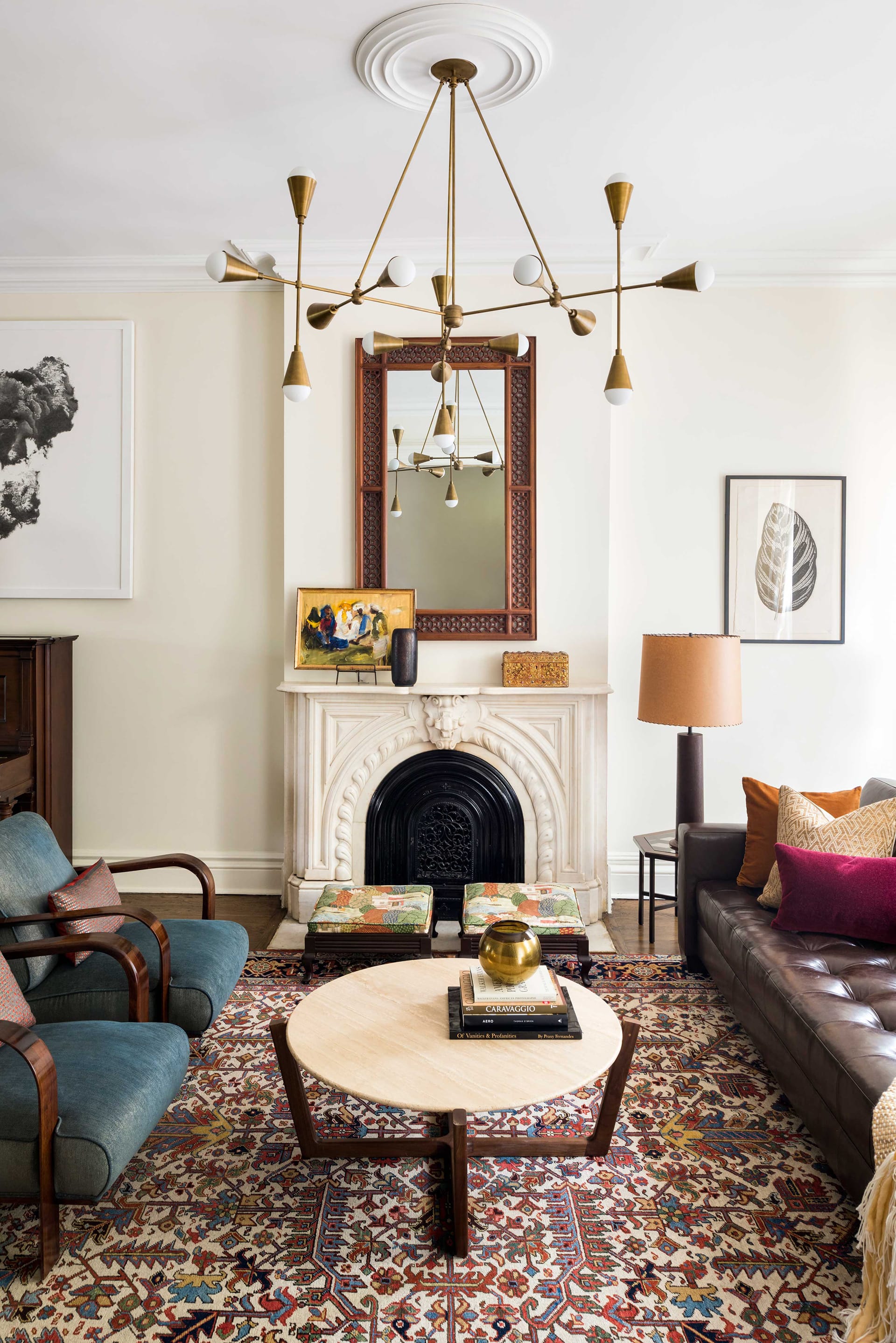 Living room with a modern chandelier, oriental rug, and historic fireplace in Fort Green
