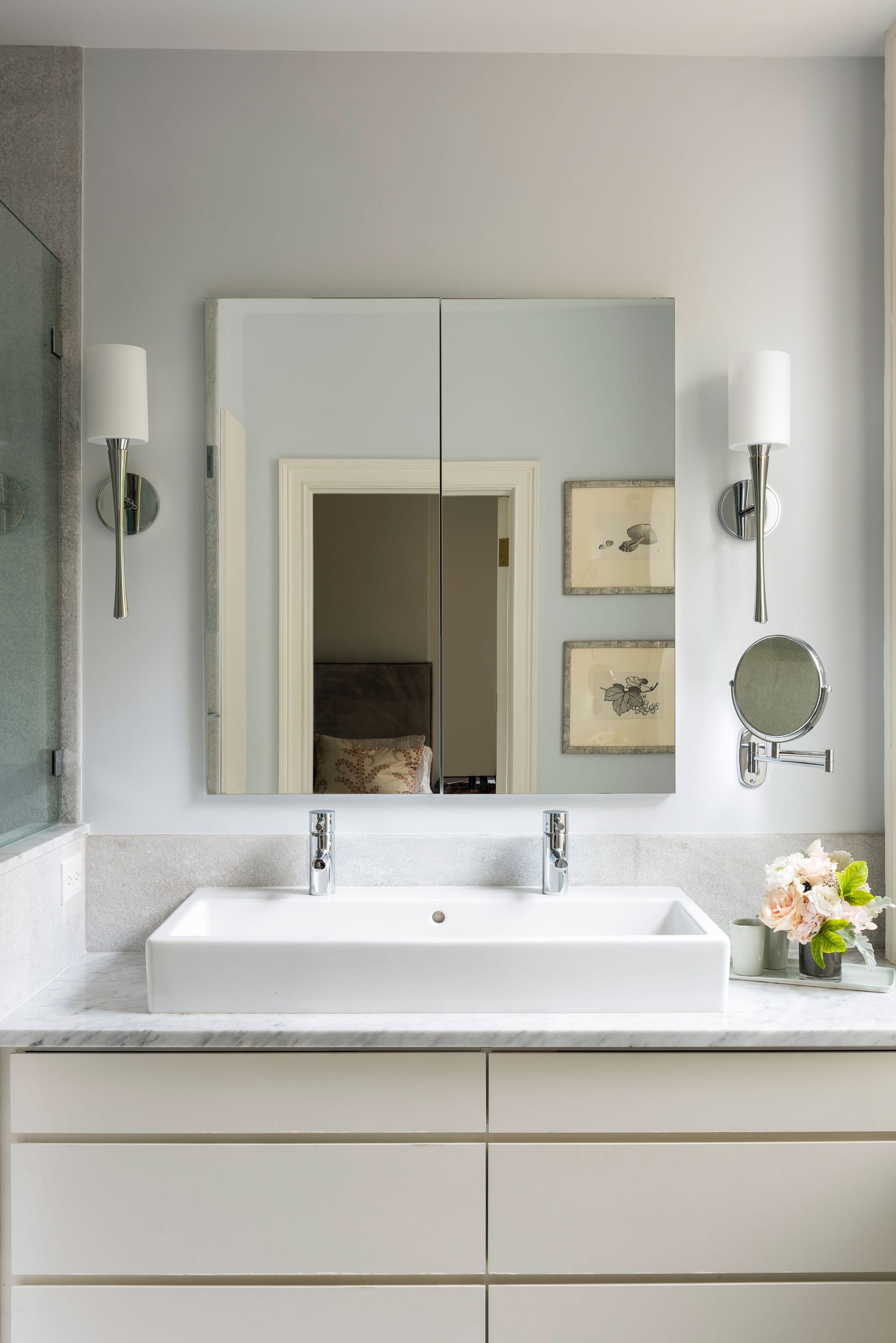 Primary bath with custom white vanity and marble countertops