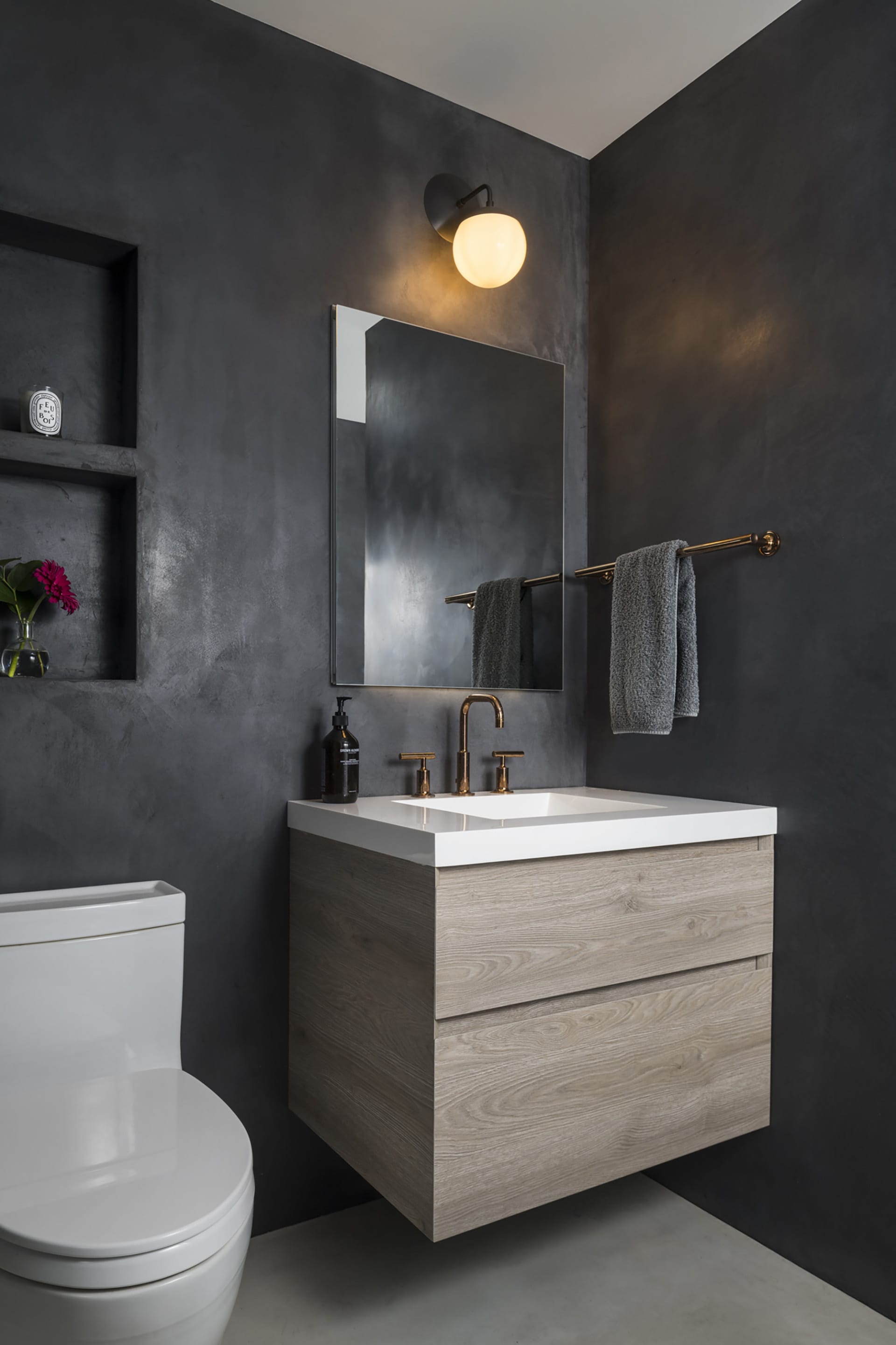 Guest bathroom with a wood vanity and dark grey Cementous walls