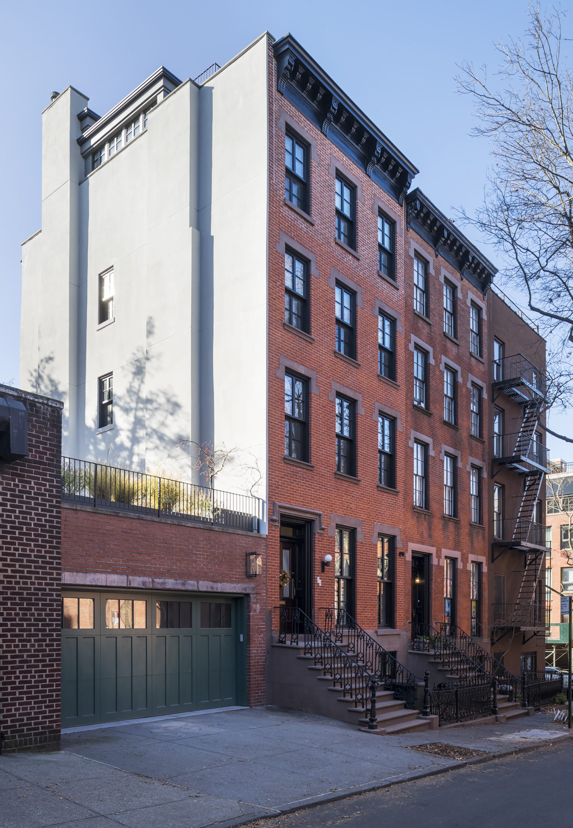 Front façade of a Brooklyn Heights townhouse with a garage next door.