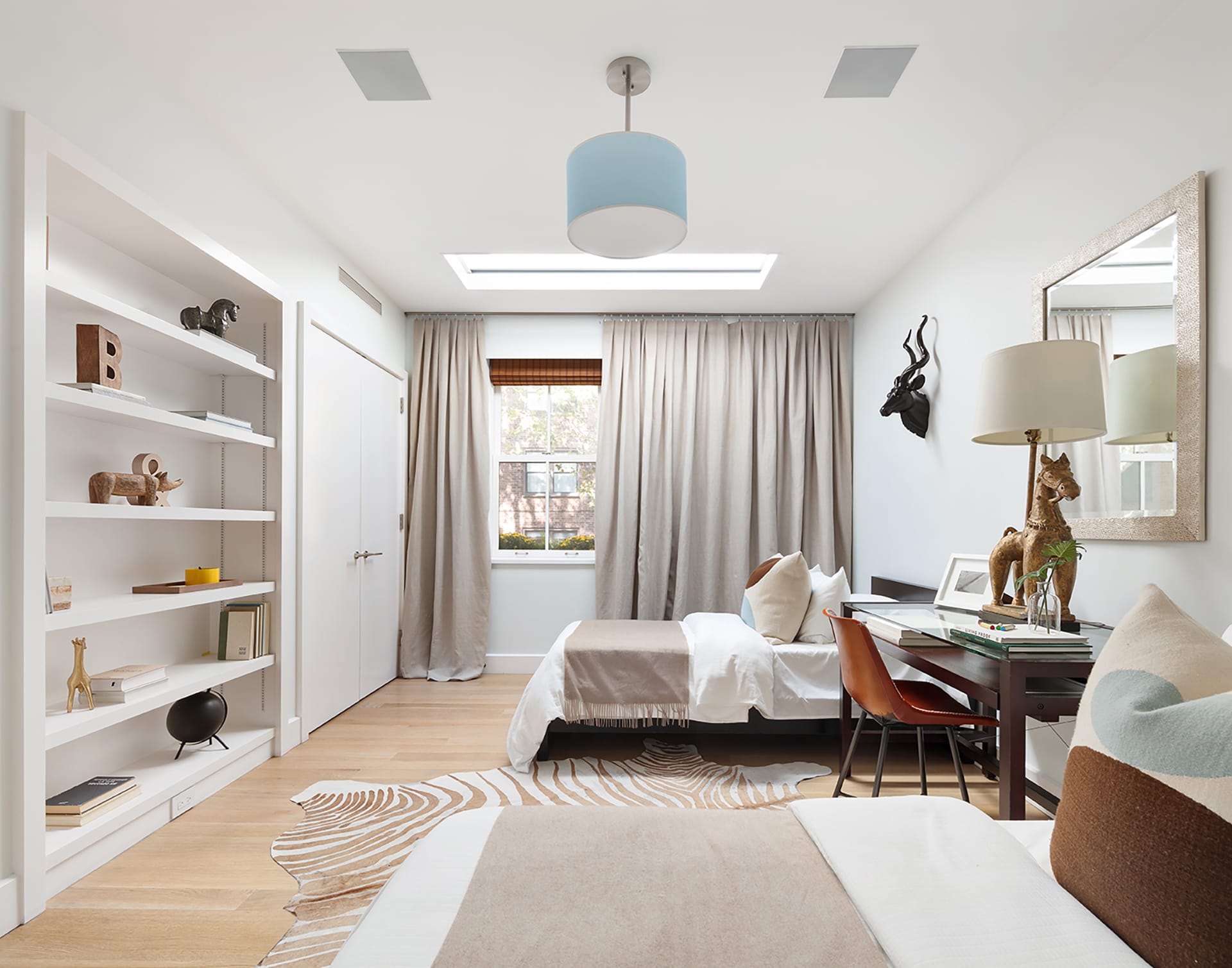 Bedroom with a skylight and wood floors in a Brooklyn Heights carriage house