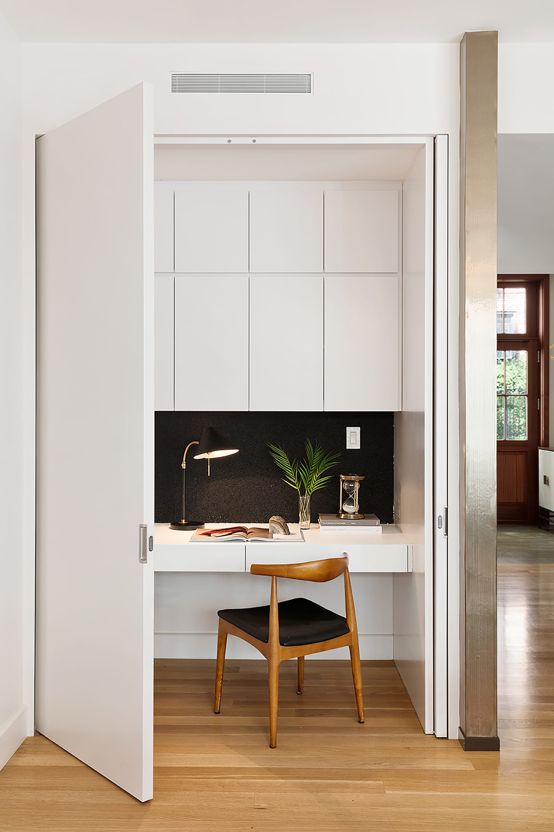 Hidden desk with white millwork in a Brooklyn Heights carriage house