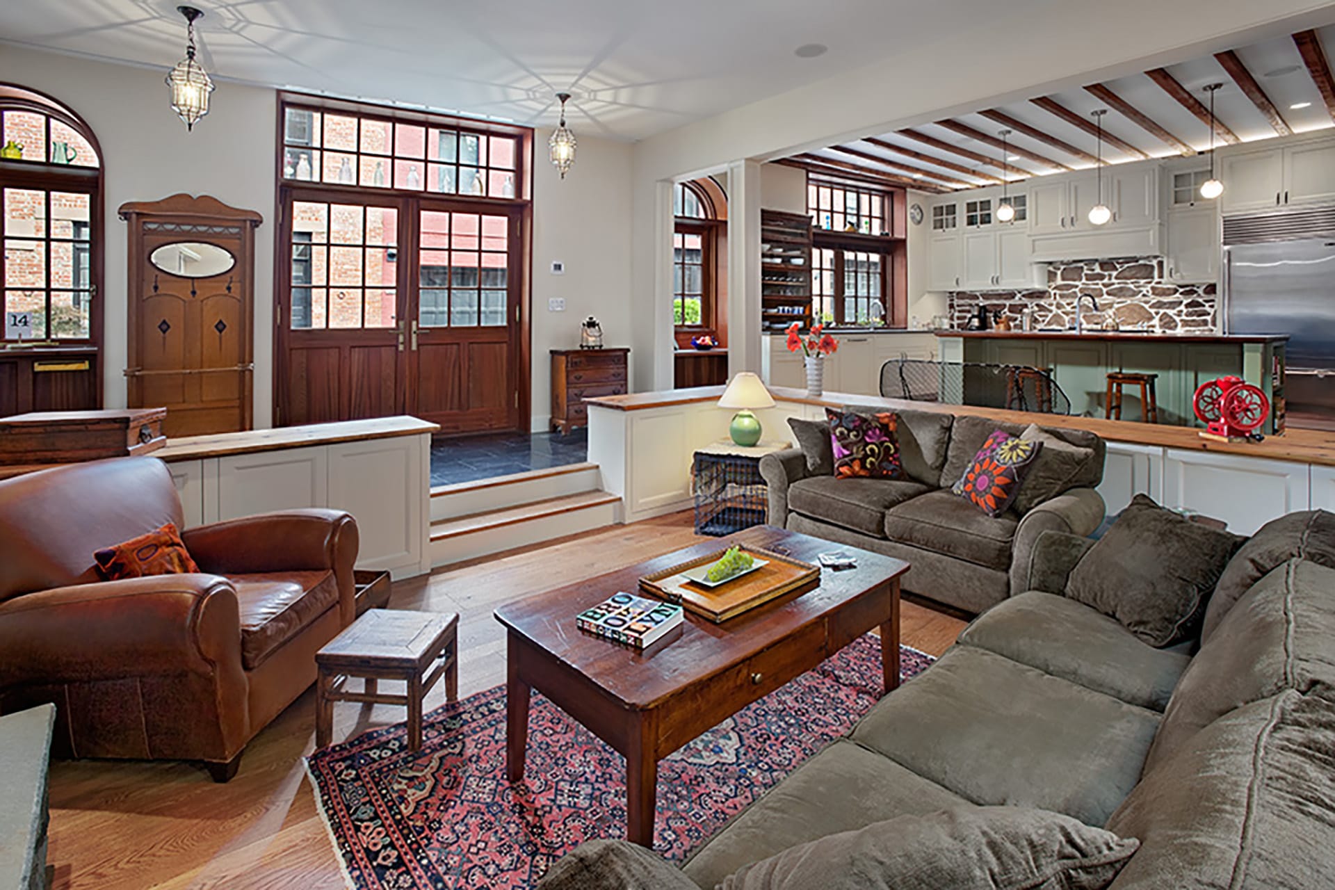 Living room with two large entry doors and traditional furnishings