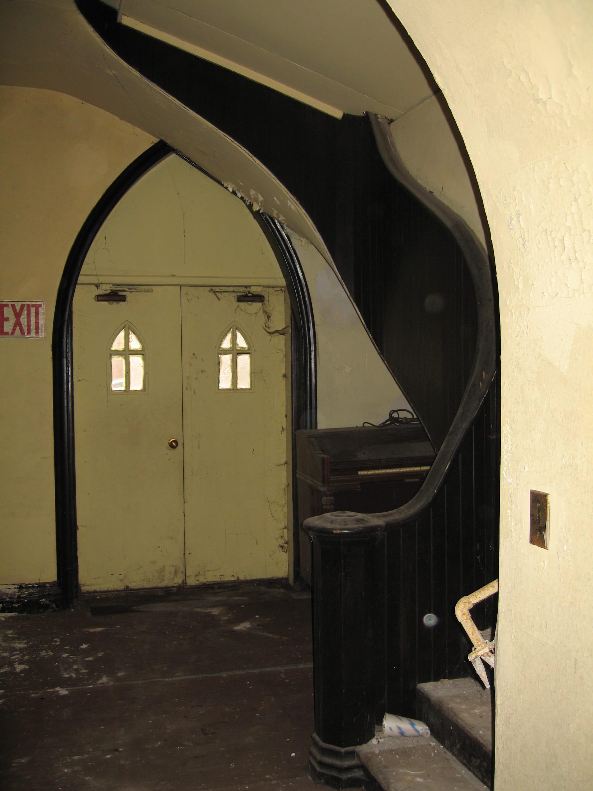 Side doorway with a pointed arch in an abandoned Cobble Hill church before our adaptive reuse renovation