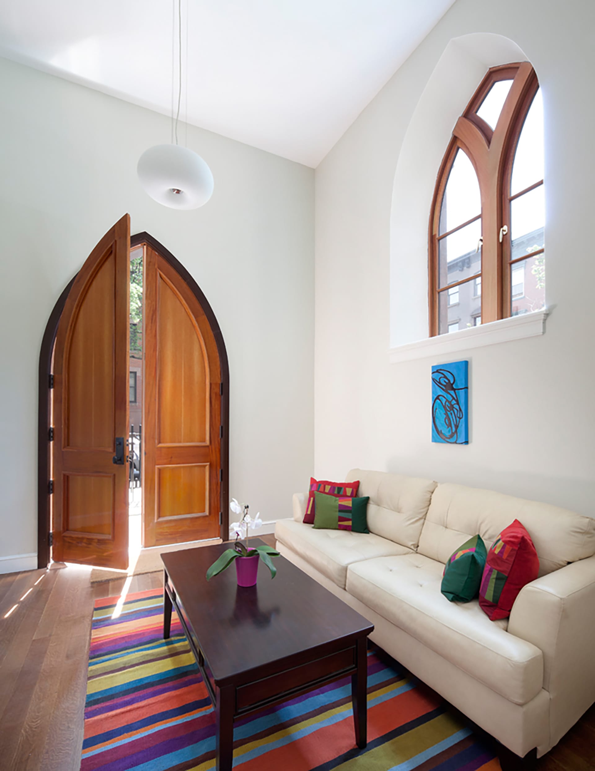 Restored doorway with a pointed arch top and a new window in a Brooklyn adaptive reuse condo conversion