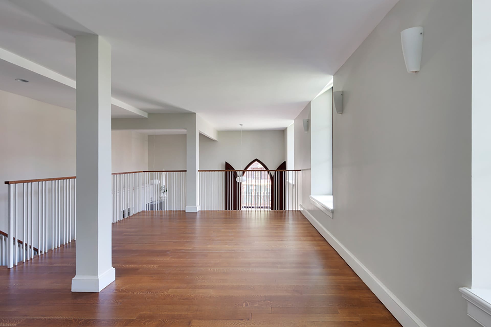 Loft-style condo with wood floors and white walls in a Brooklyn condo building