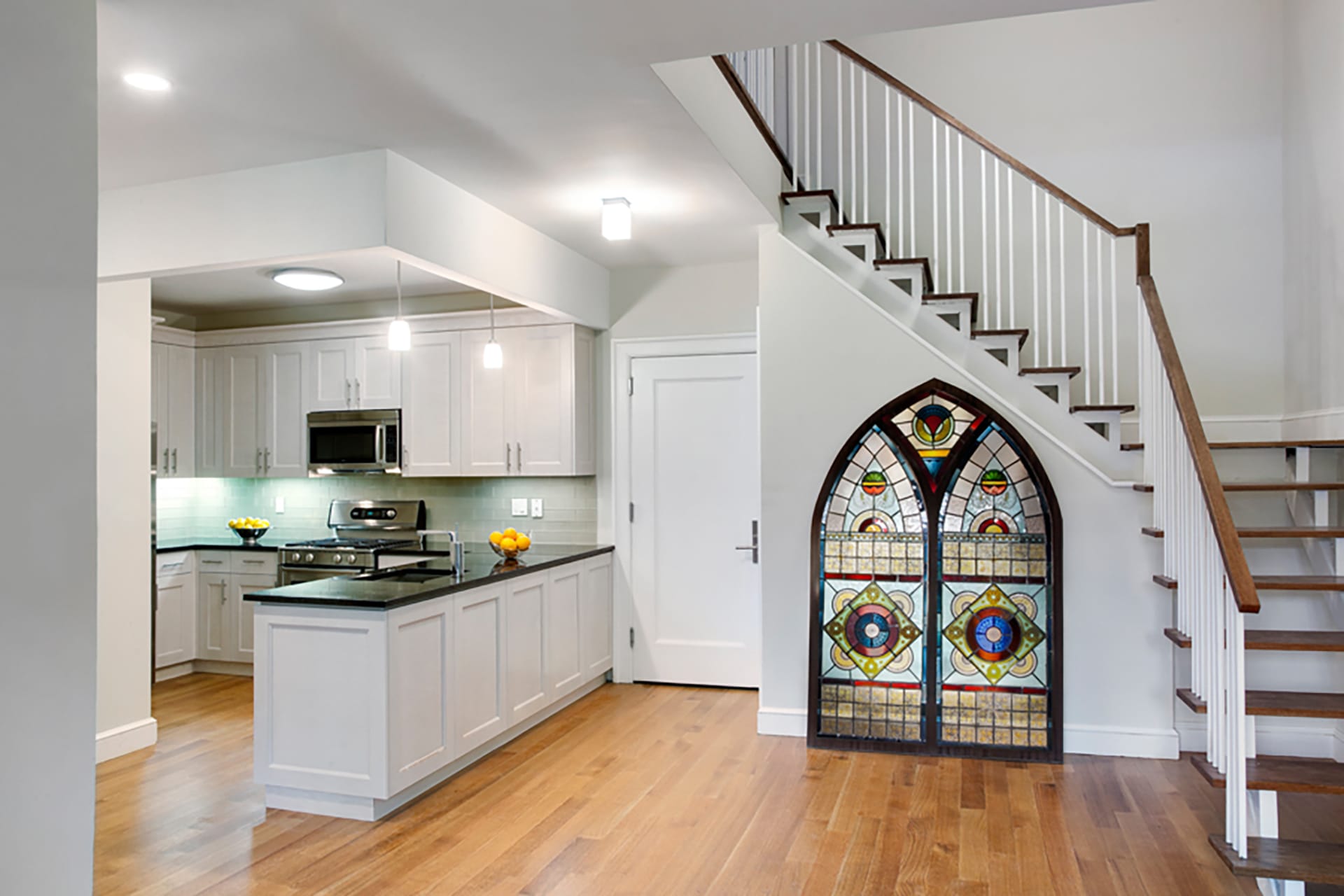 Kitchen with preserved stained glass window in a Brooklyn condo