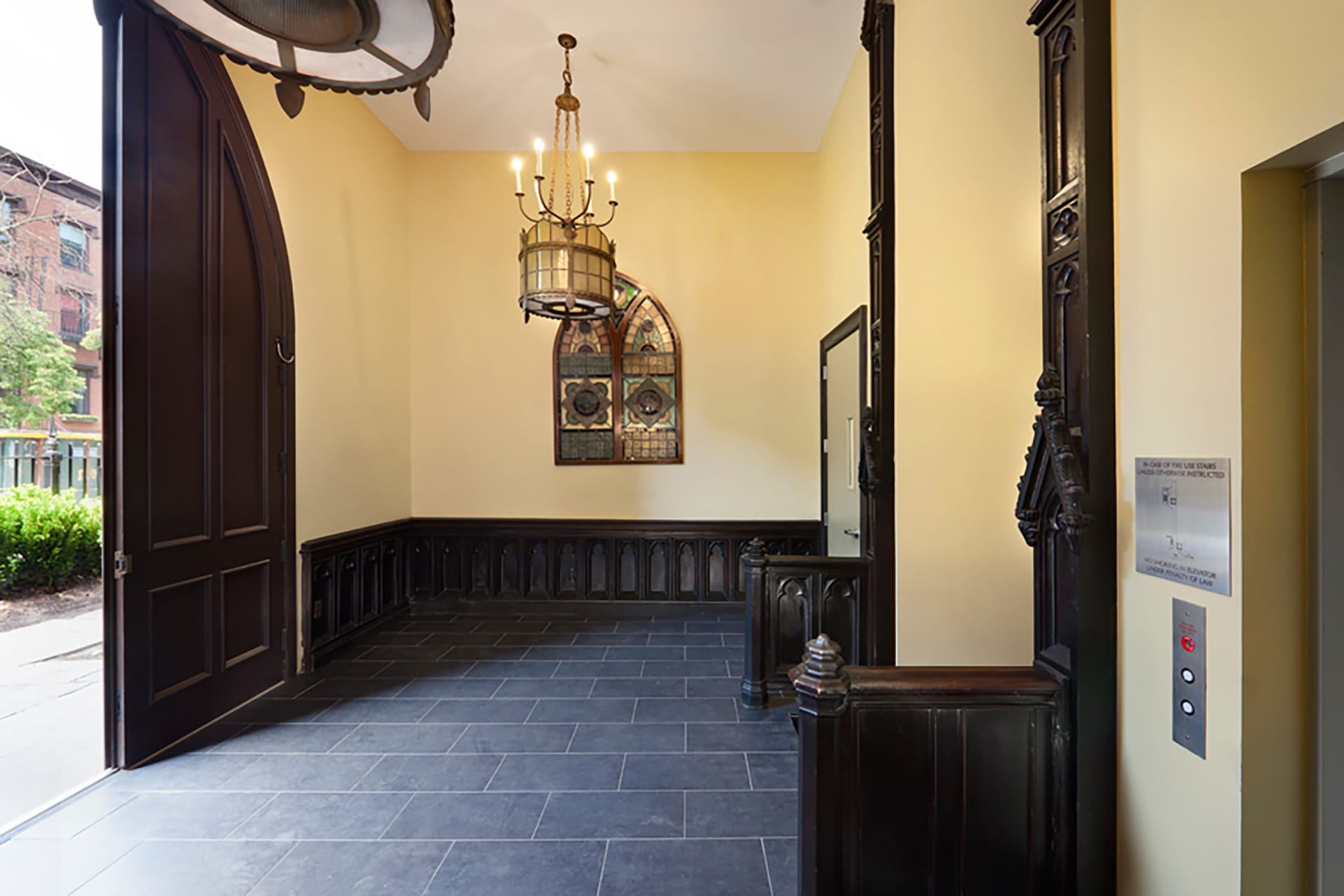 Front entrance with re-made historic front door, restored original woodwork, and slate floors in a Cobble Hill condo building
