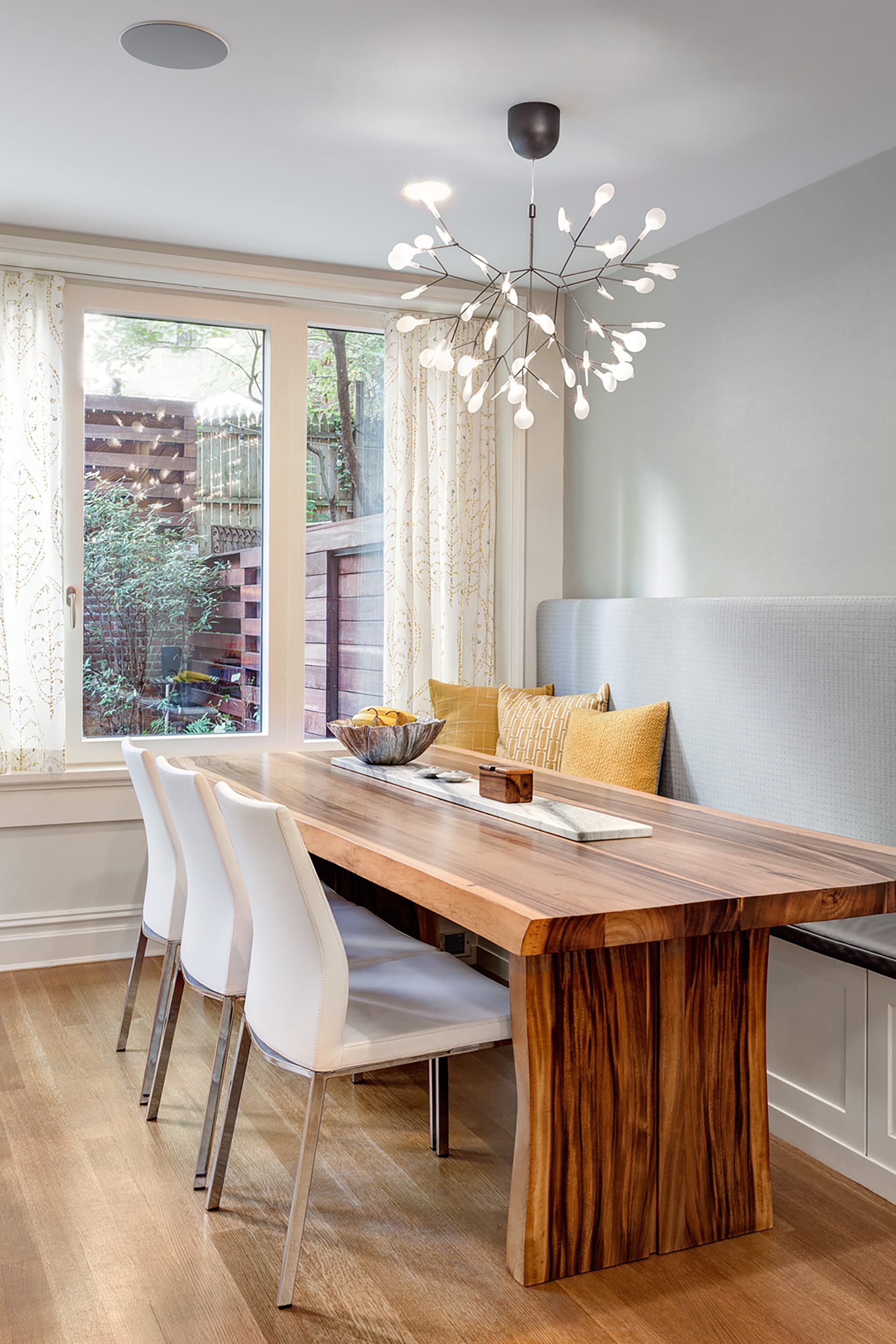 Breakfast nook with a chandelier and sliding glass doors leading out to a roof deck.