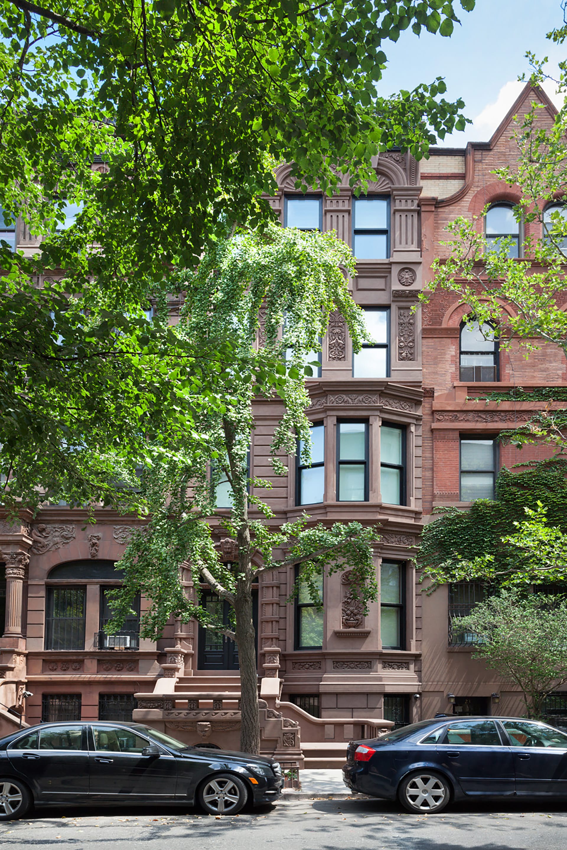 Front façade of a Greek Revival brownstone on the Upper West Side of Manhattan with reinstalled stoop