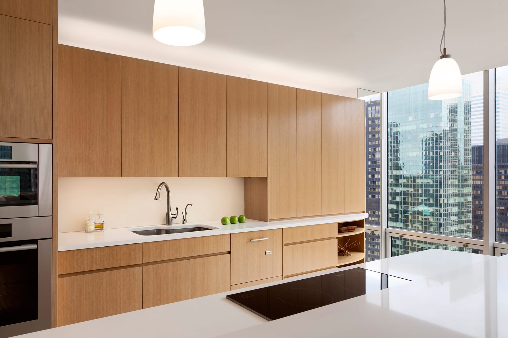 Kitchen with white countertops and light wood cabinetry.