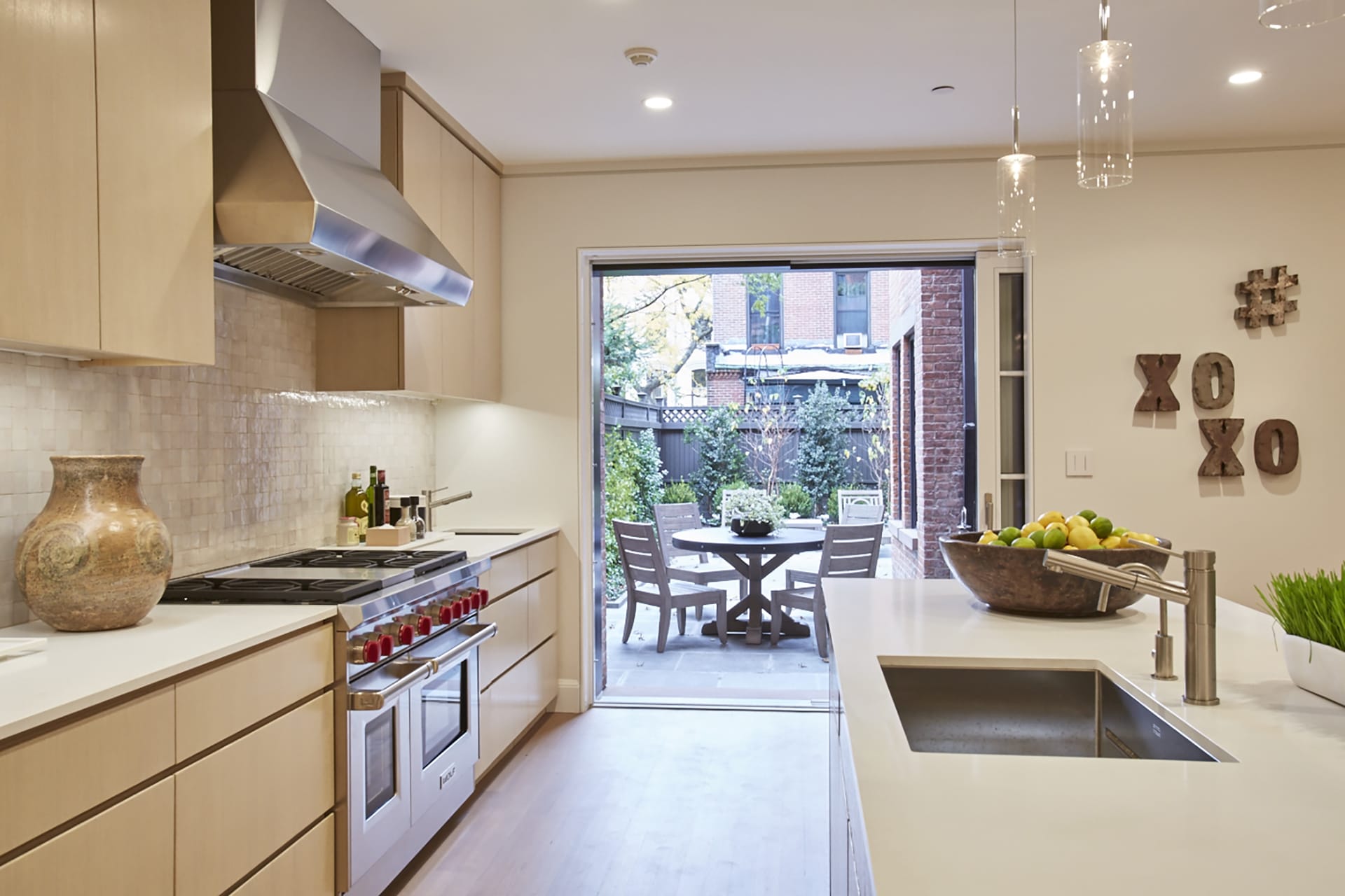 Garden level kitchen in a Brooklyn Heights Passive House with doors opening to the rear garden.