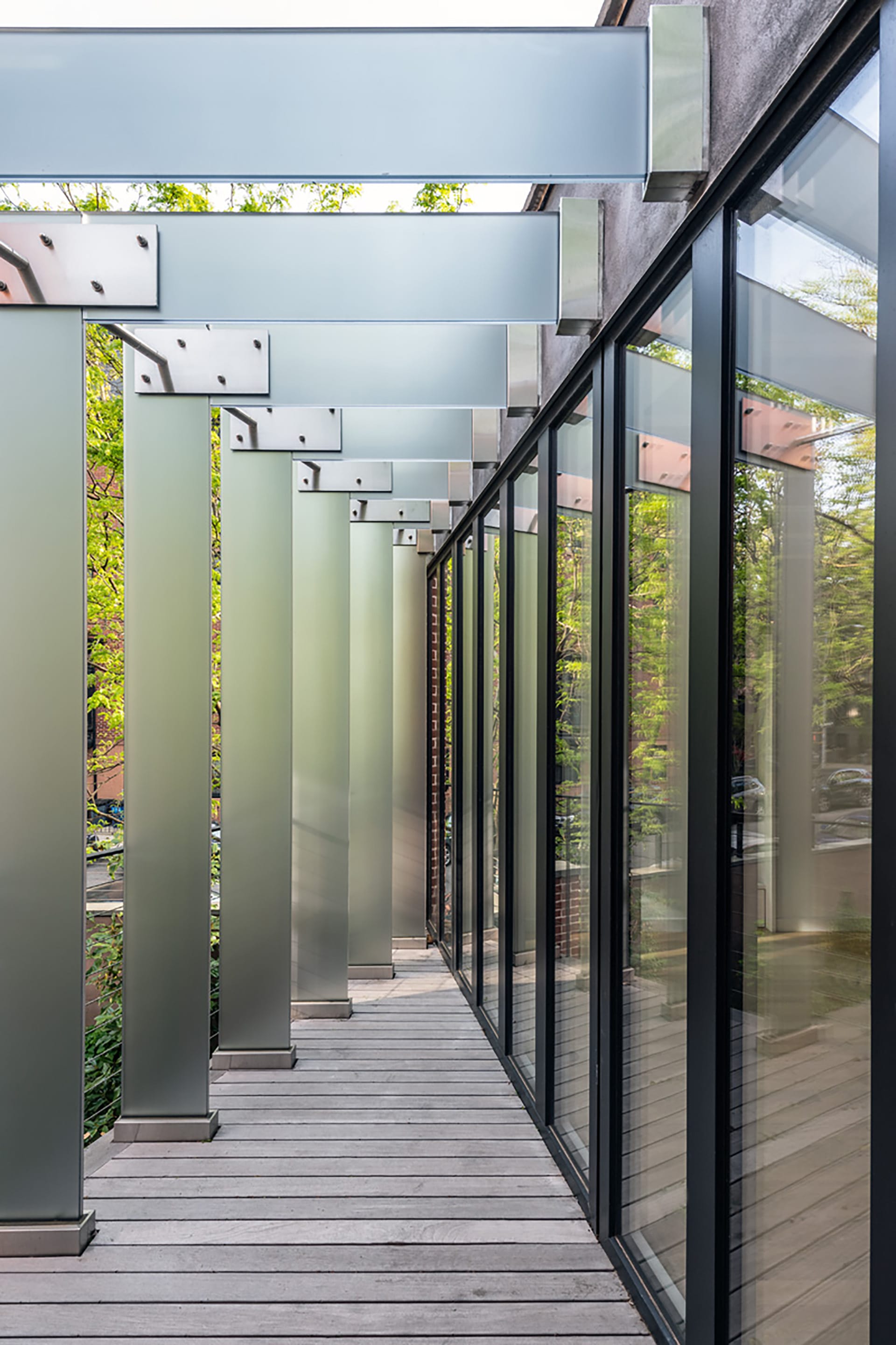 Balcony above a Park Slope garage with glass slats providing shading.