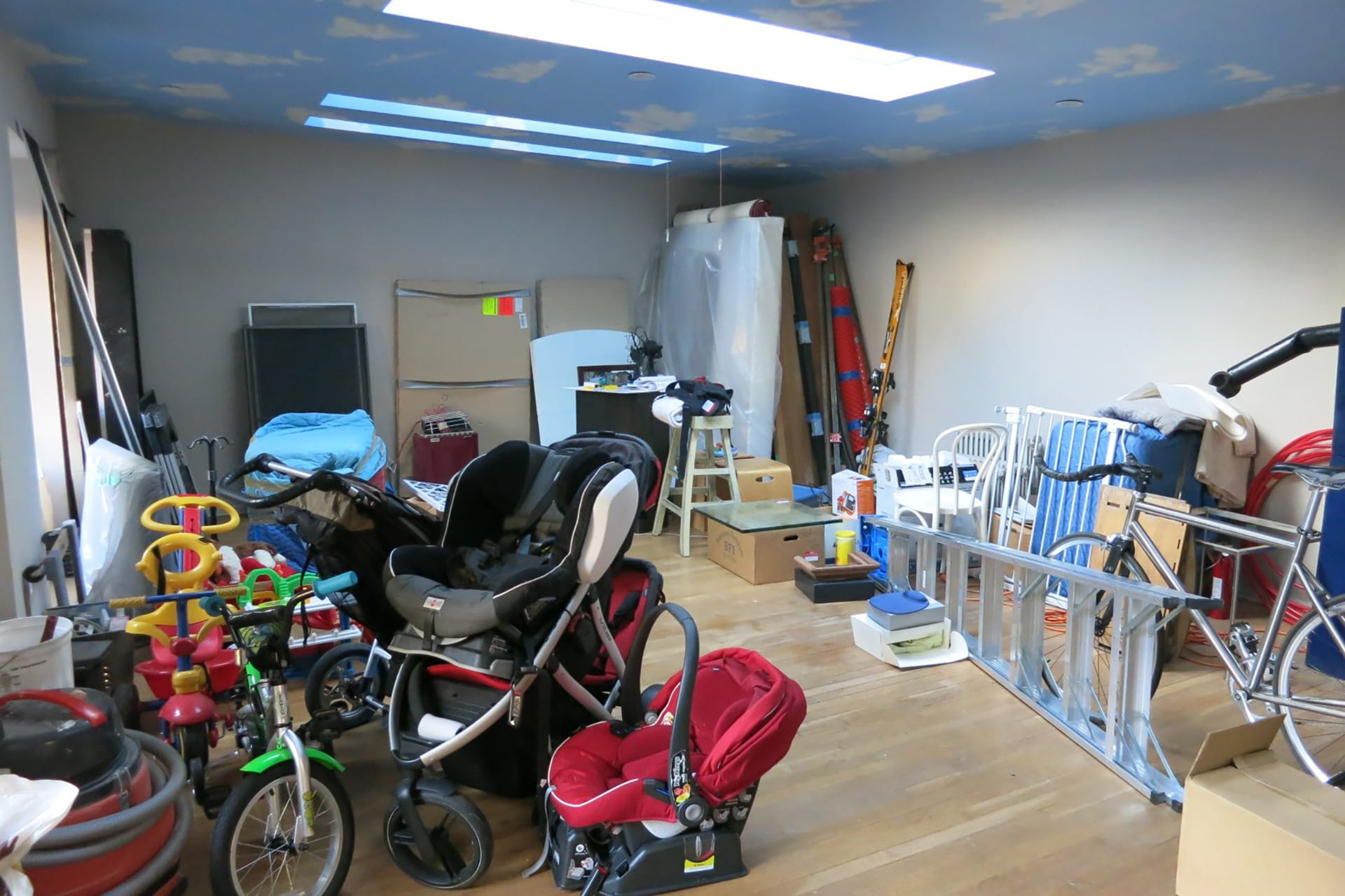 View into an exercise studio above a detached garage before our renovation with a sky mural on the ceiling