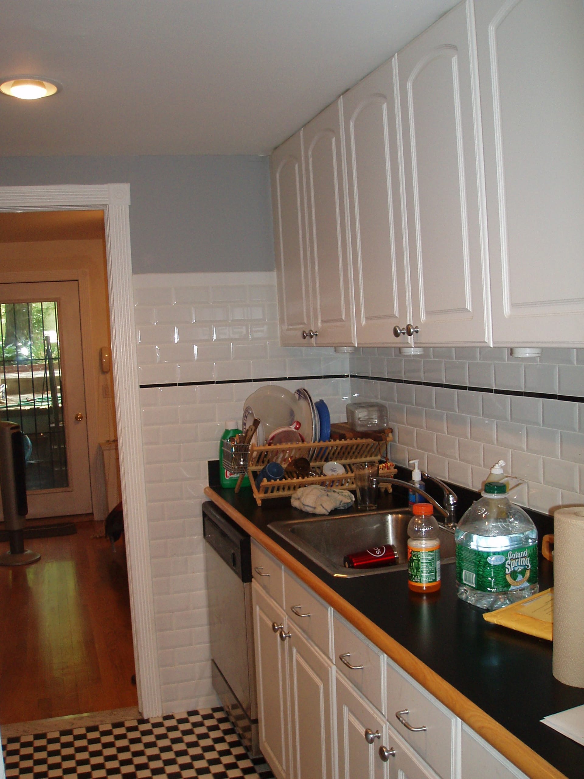 Kitchen with white subway tiles and shaker-style white cabinets before our renovation of a Cobble Hill rowhouse