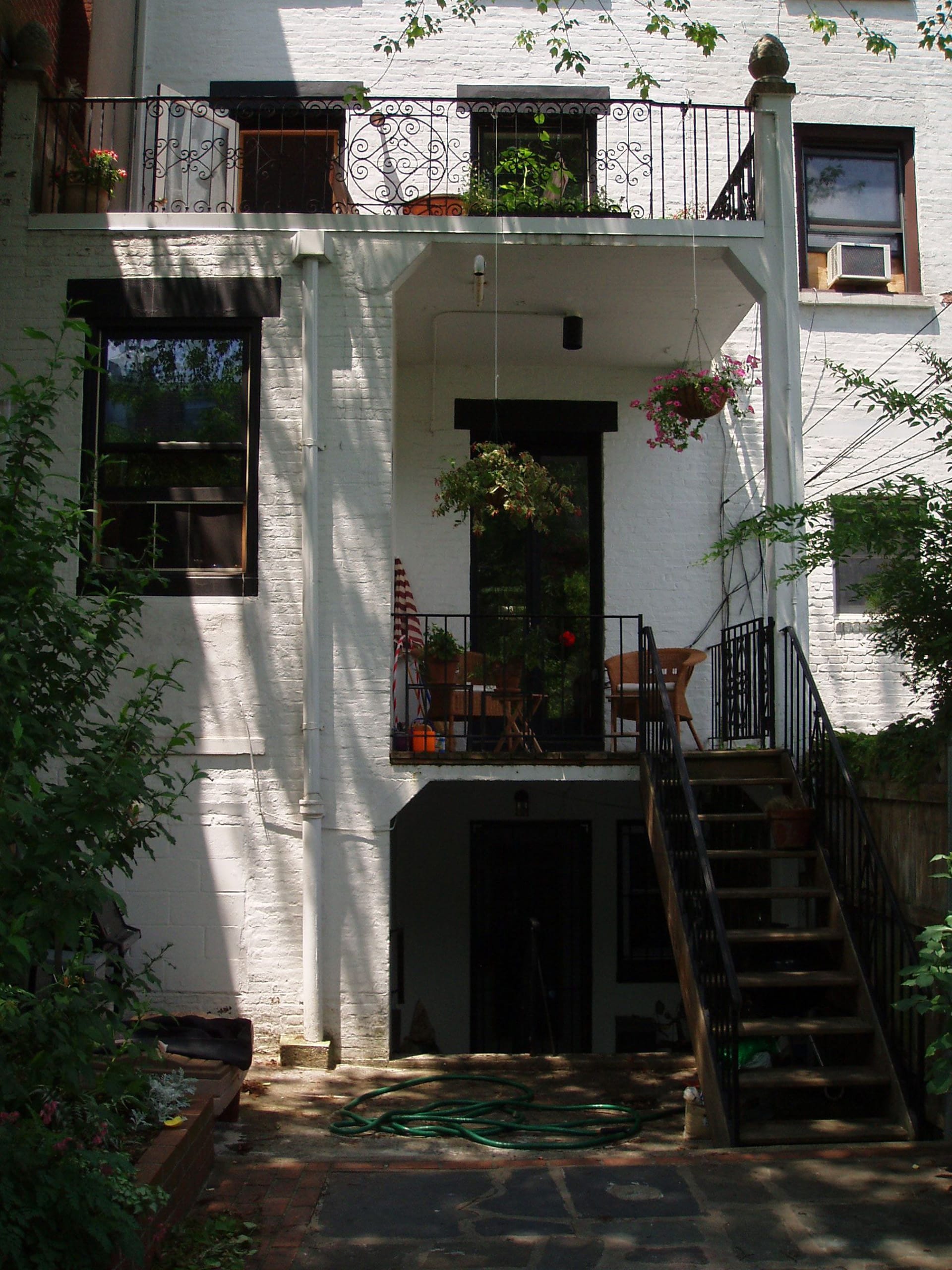 White painted brick rear façade of a Cobble Hill townhouse before our renovation