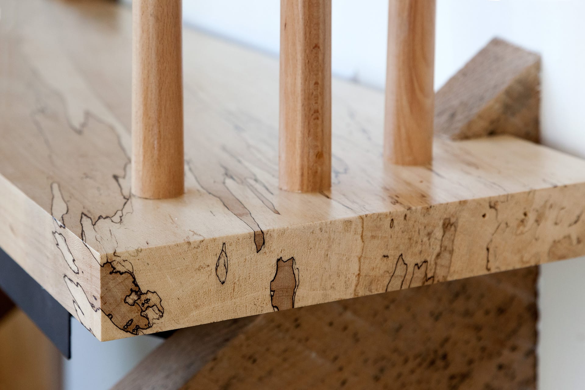 Detail of an entry staircase custom made from reclaimed wood.