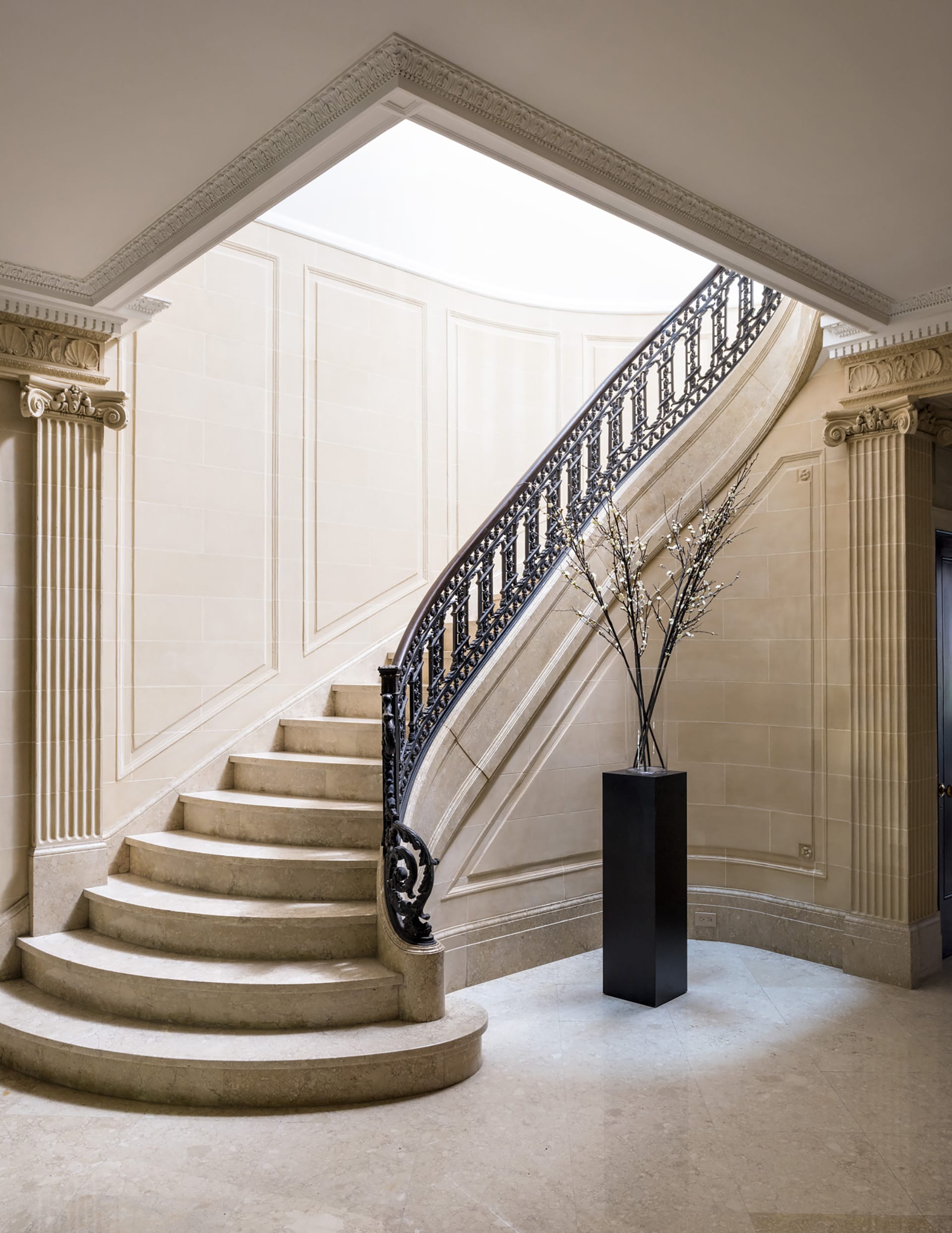 Grand entrance with marble floors, stair, and walls, and intricate crown moldings.