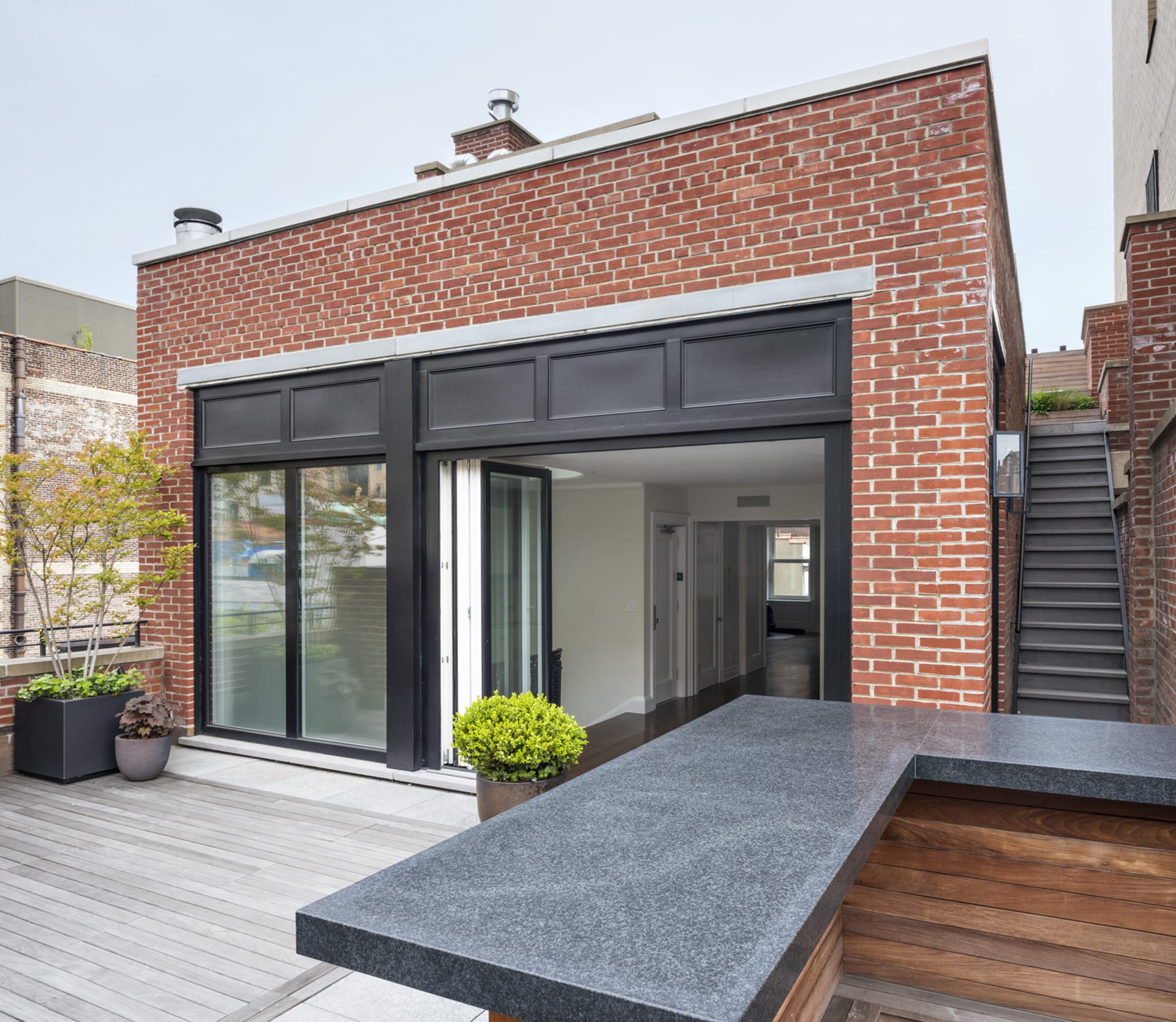 Penthouse with large folding glass doors and roof deck in an Upper West Side mansion.