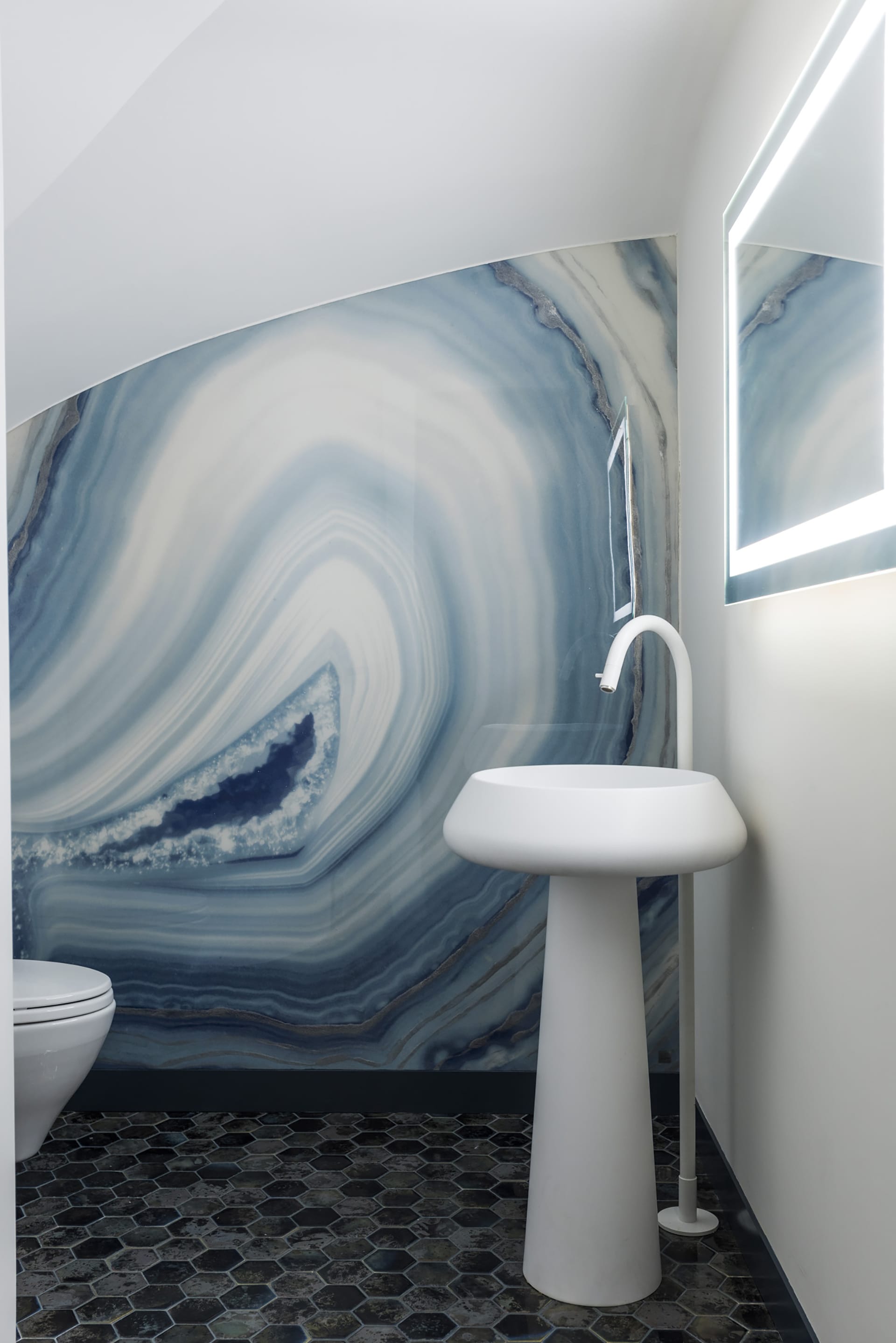 Powder room with tile floors and a crystal-inspired accent wall.