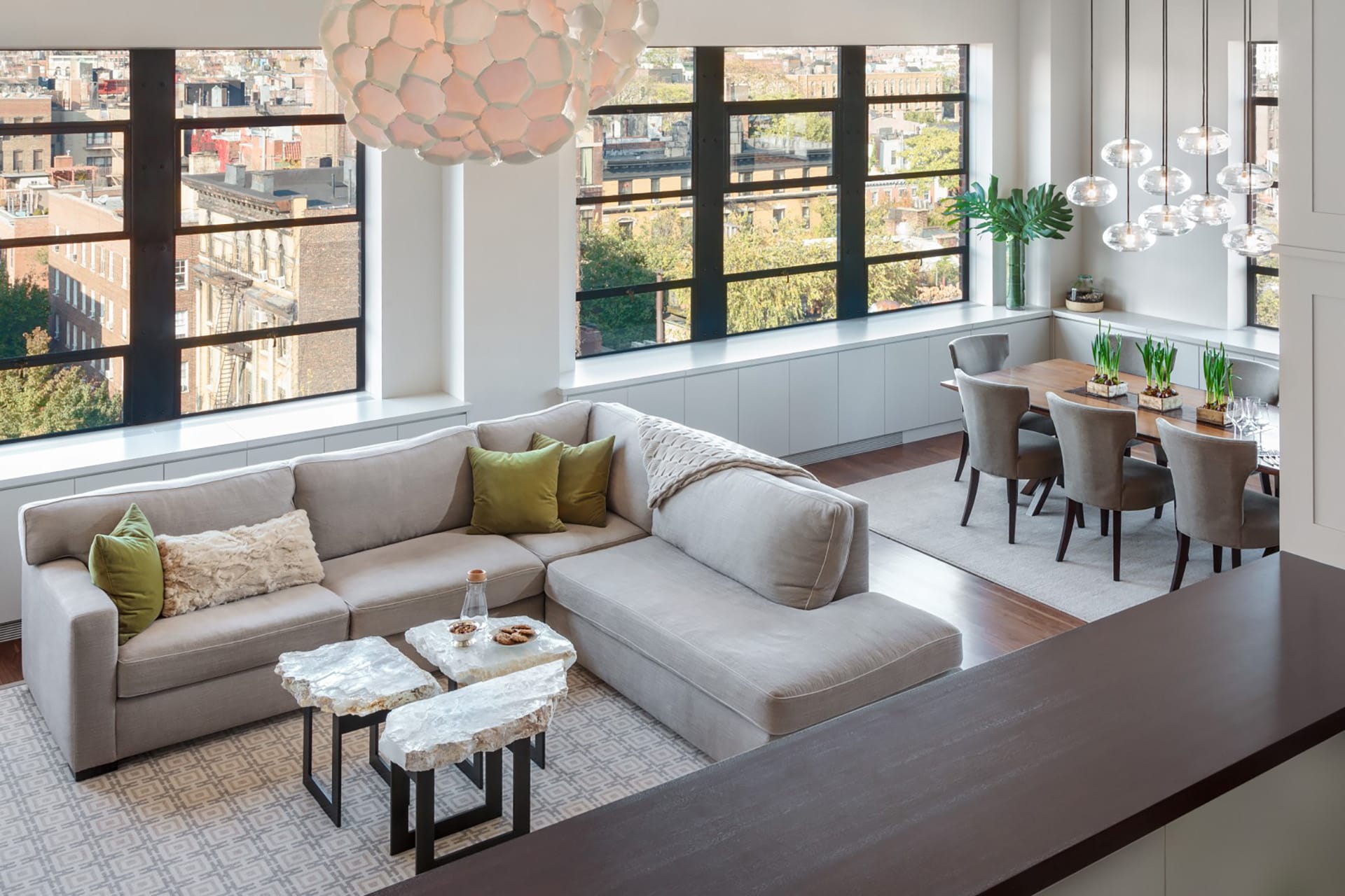 Looking down at the living and dining area from an upper-level balcony in a West Village penthouse.