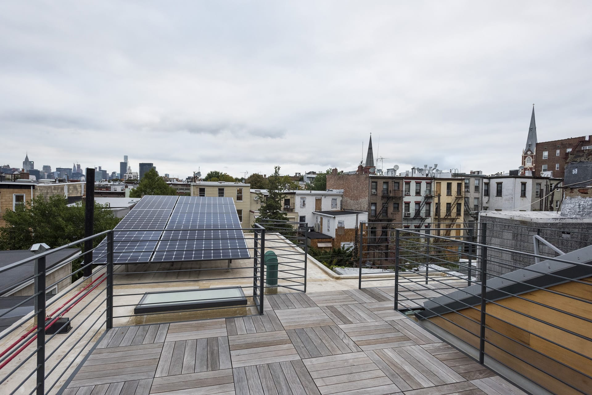 Greenpoint roof deck with wood pavers and a solar array